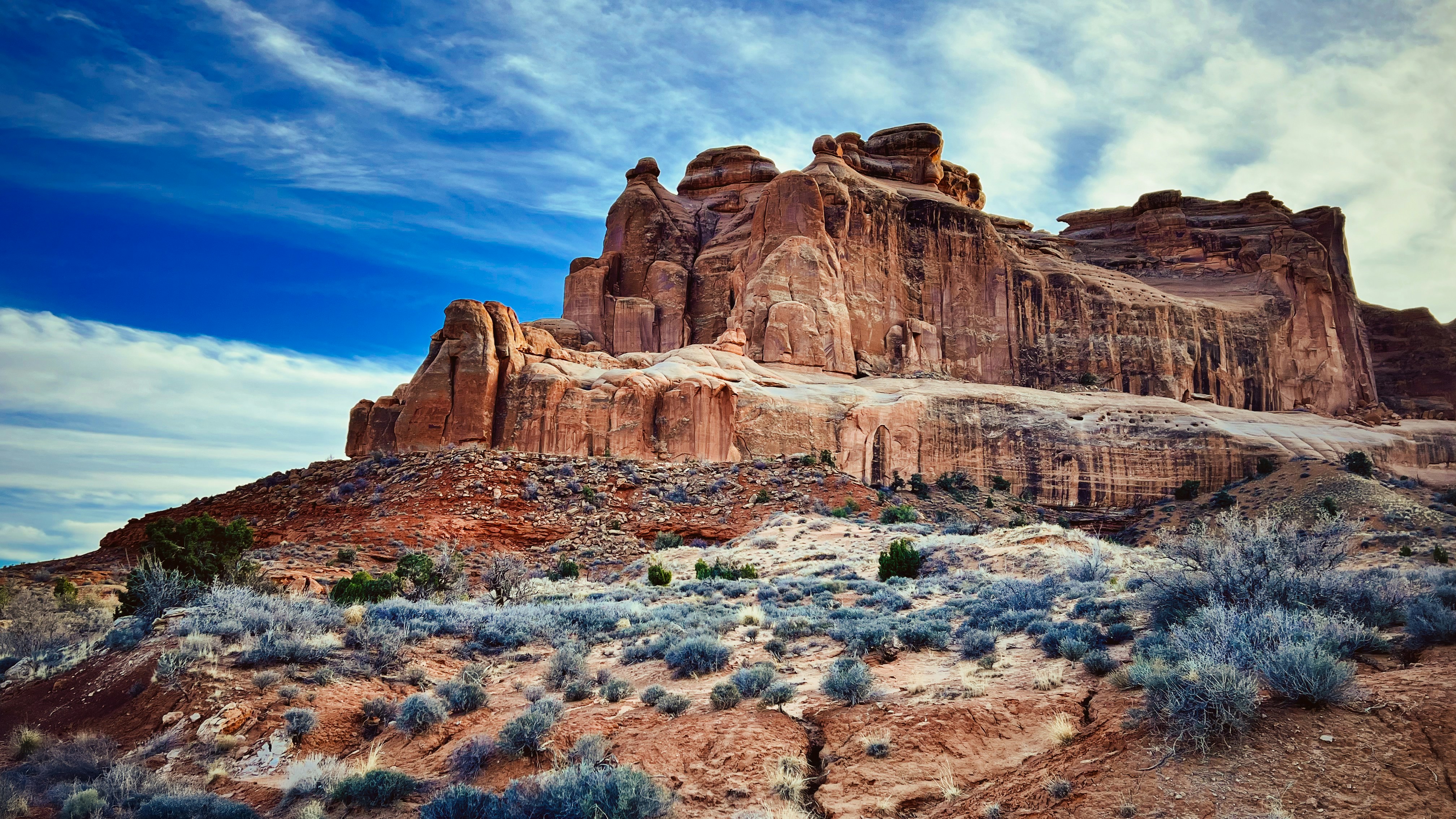 Dramatic desert landscape with rock formations.