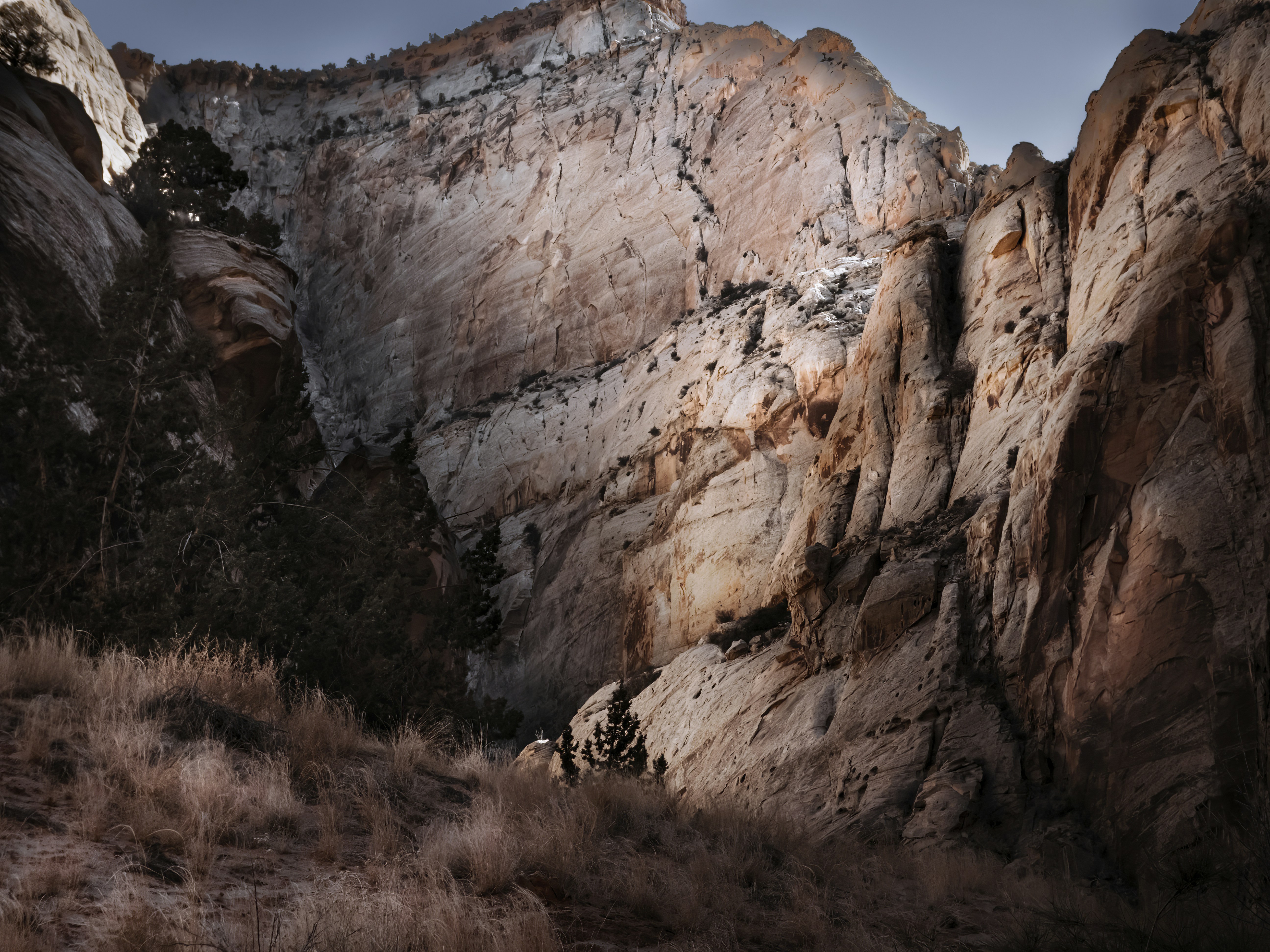 Rugged canyon walls bathed in dramatic sunlight.