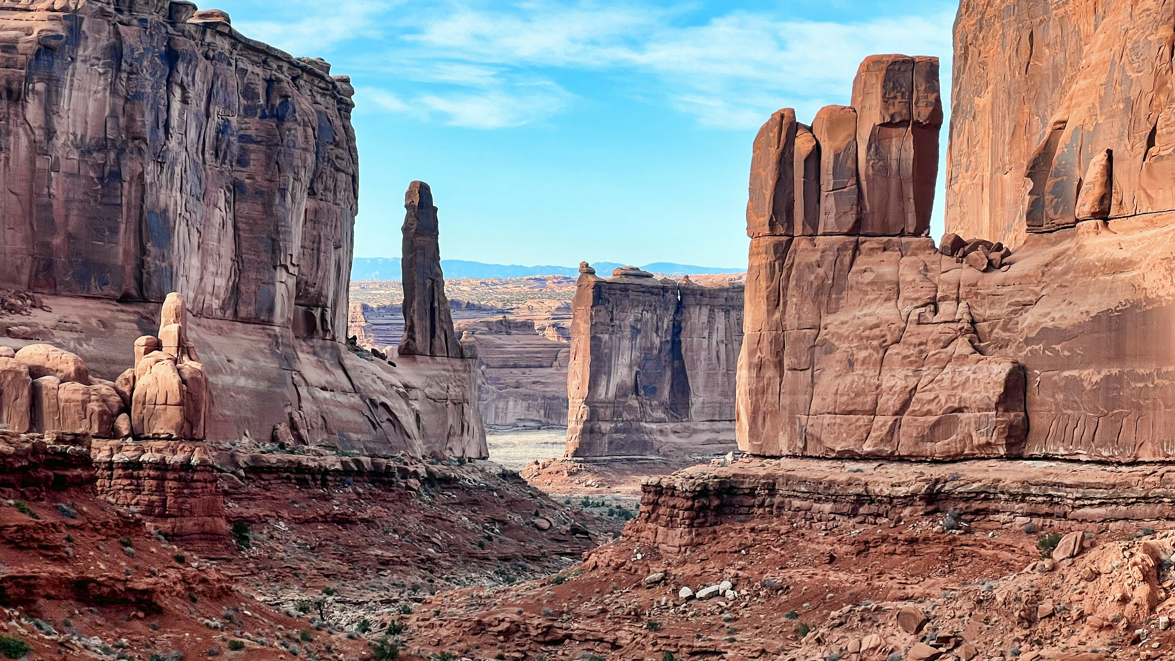 Red rock formations stand tall in a desert landscape.