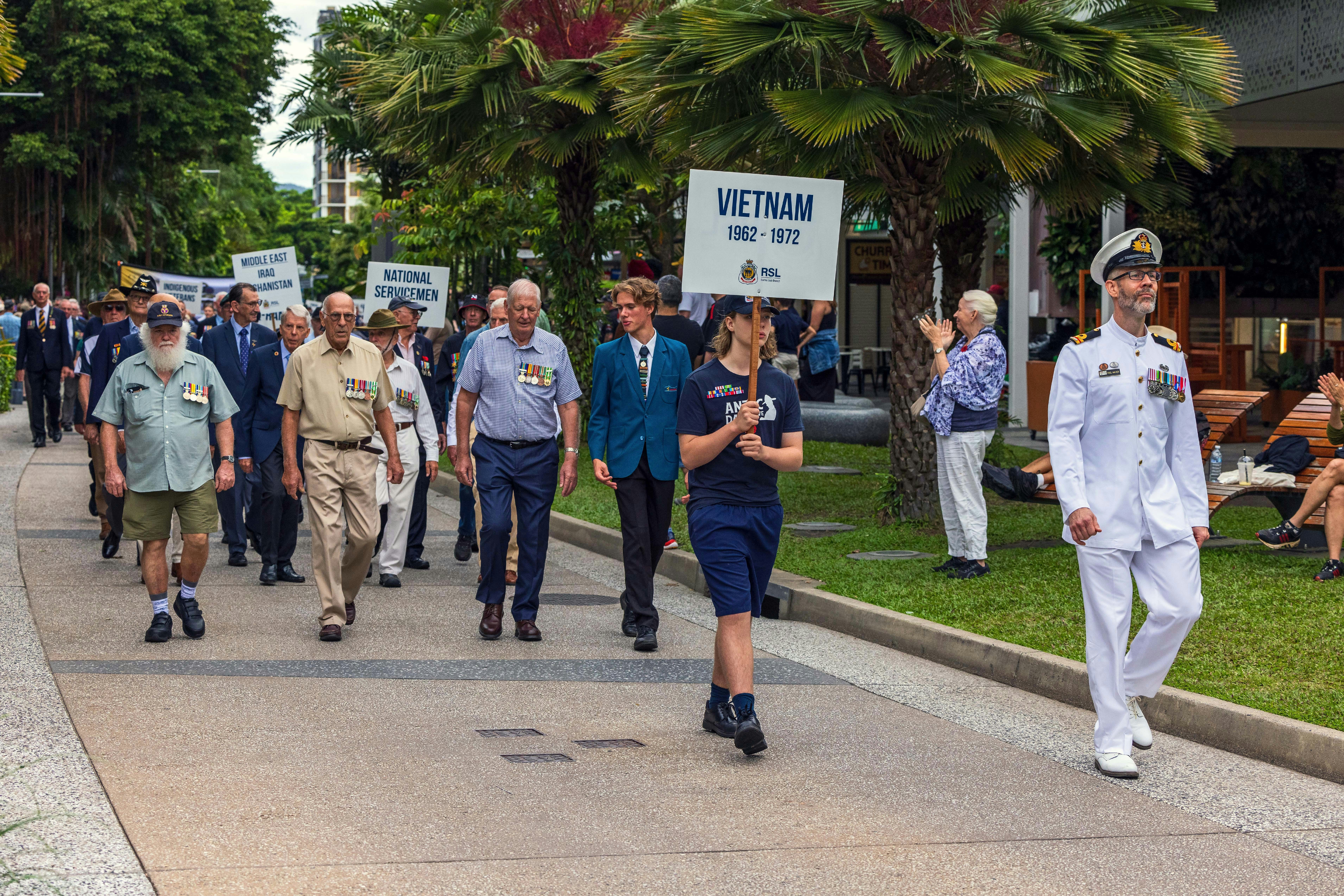 Veterans march in a parade honoring their service.