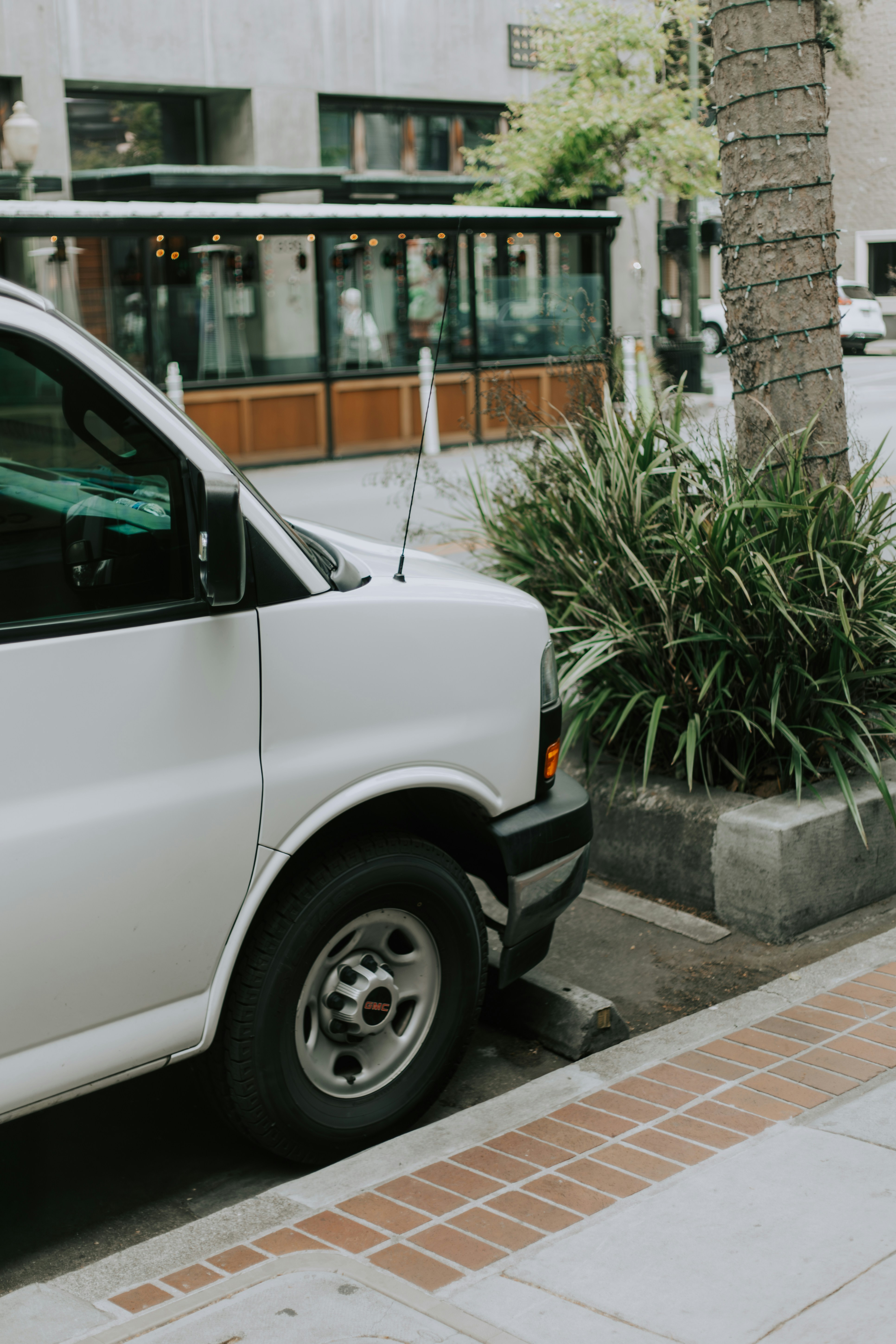 A white van is parked on a city street.