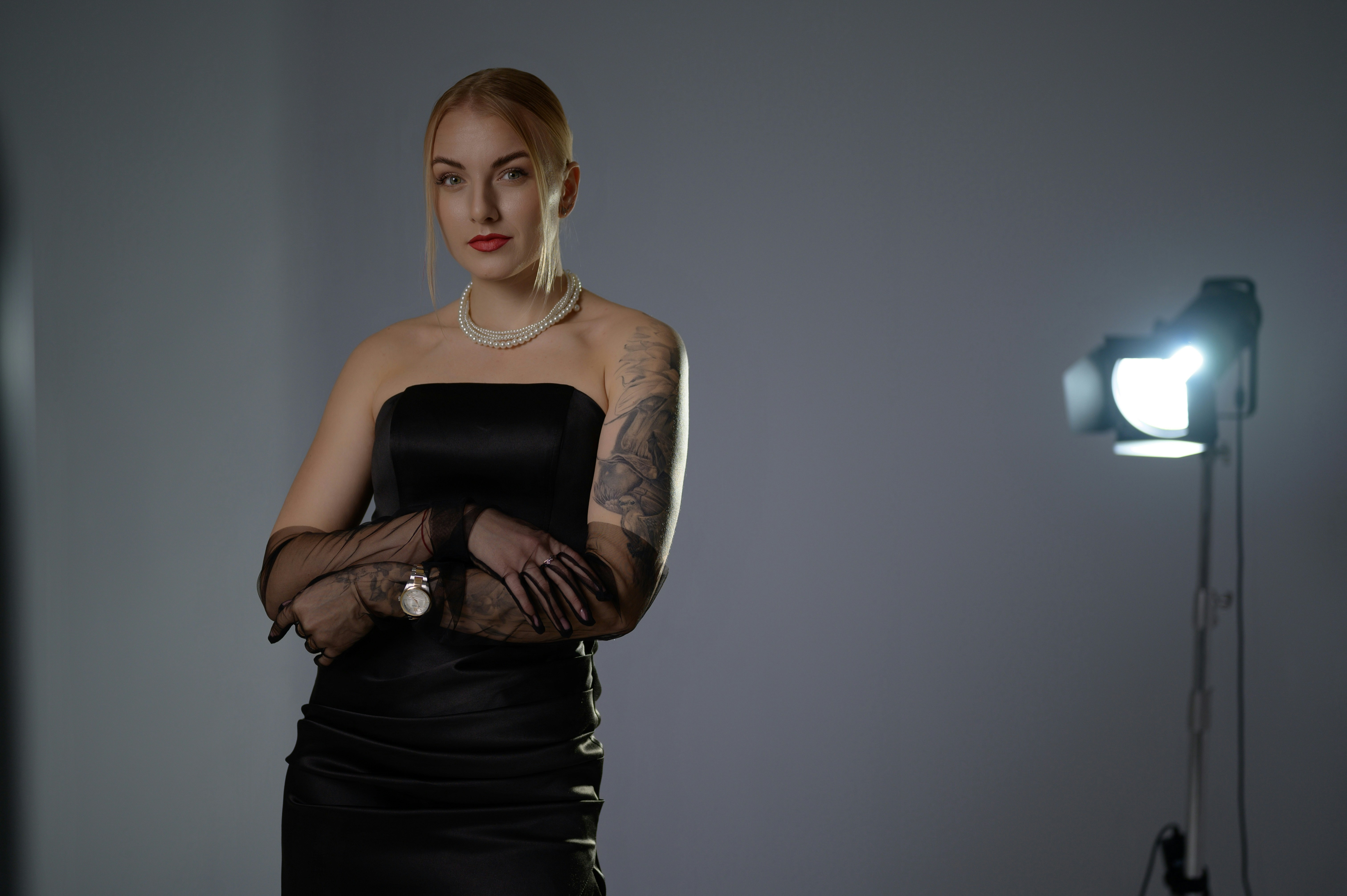 A woman poses in studio lighting.