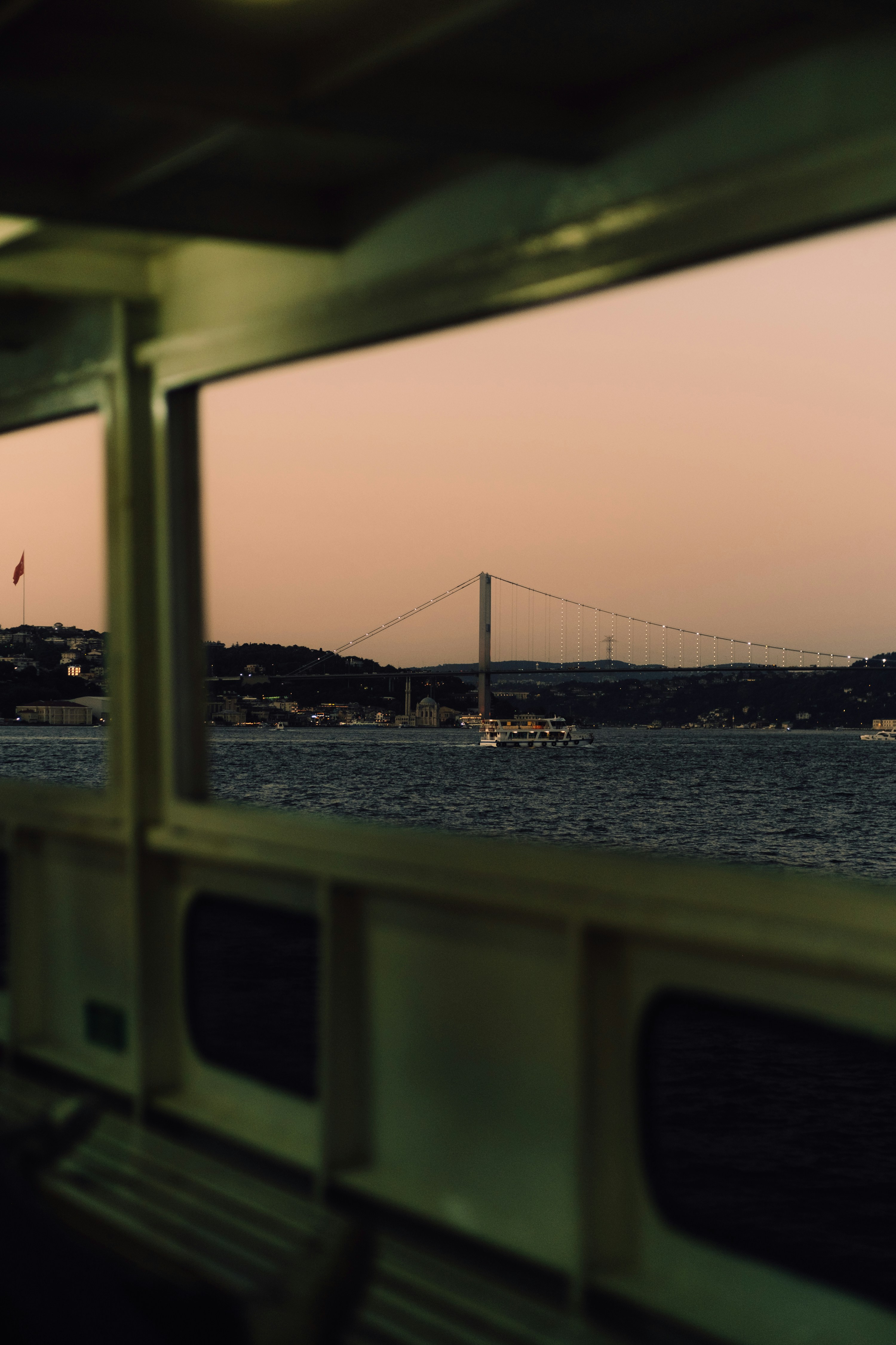 A bridge is seen through a boat's window.