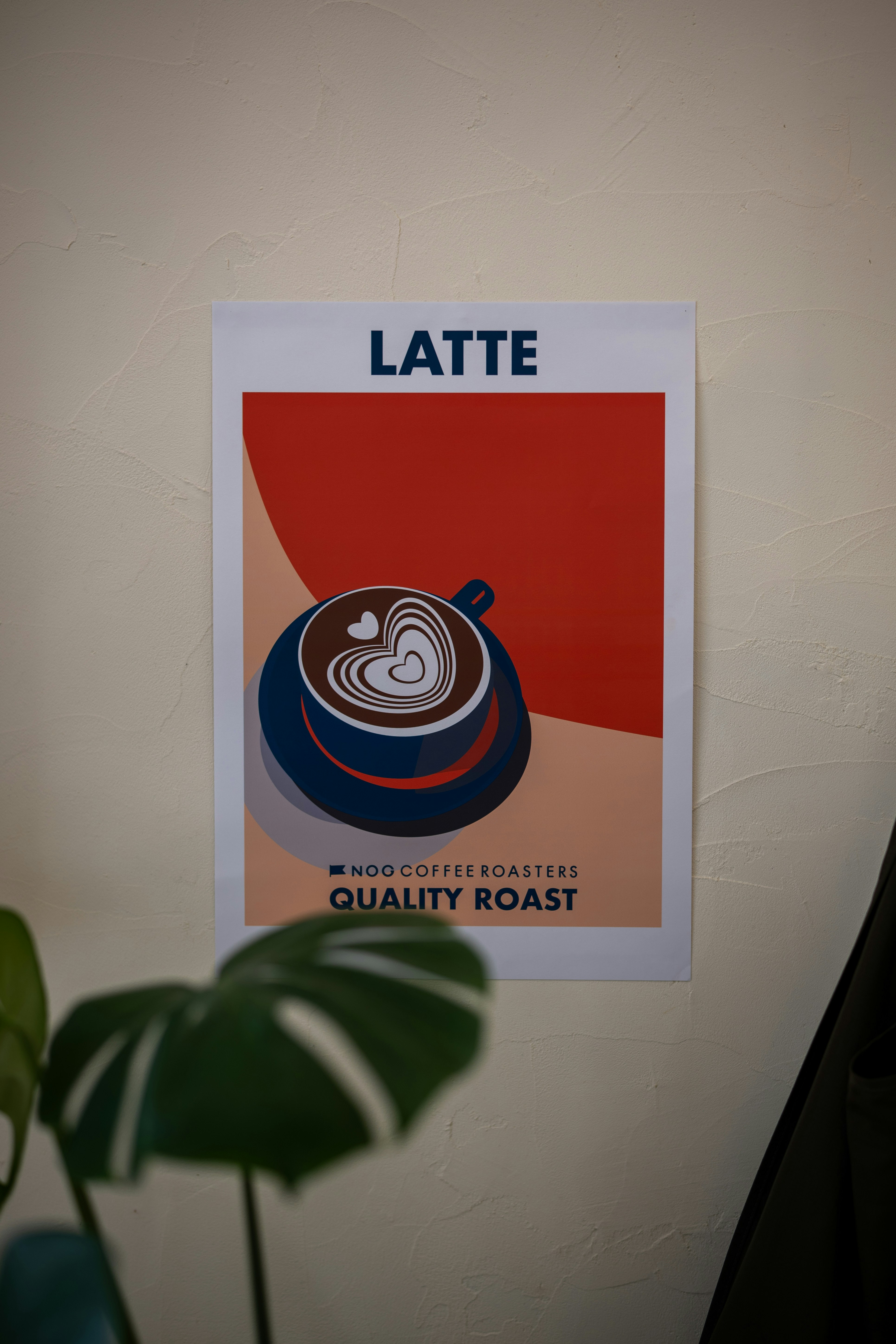 A poster advertising "latte" coffee hangs on the wall.