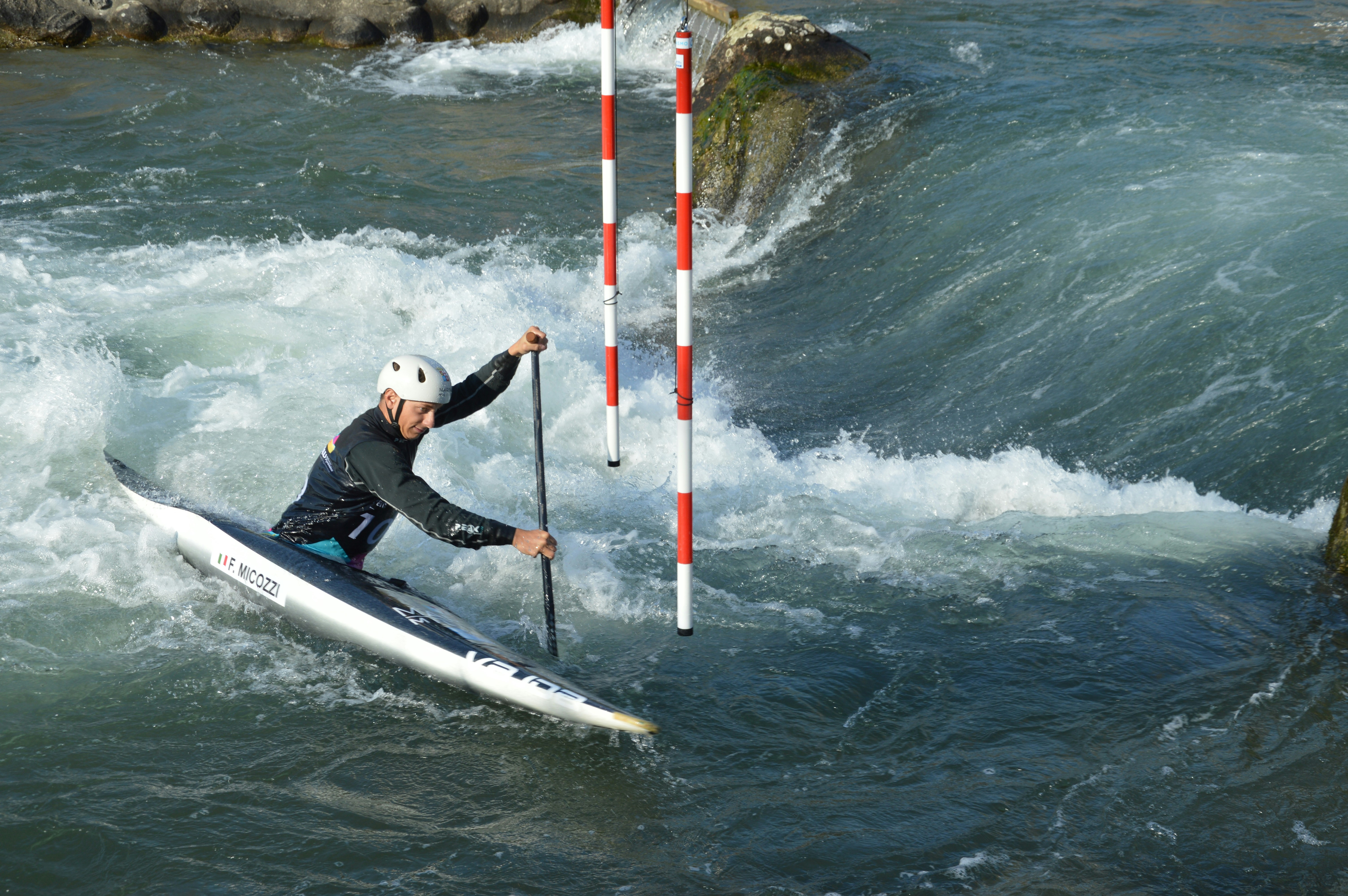 A kayaker navigates whitewater rapids.