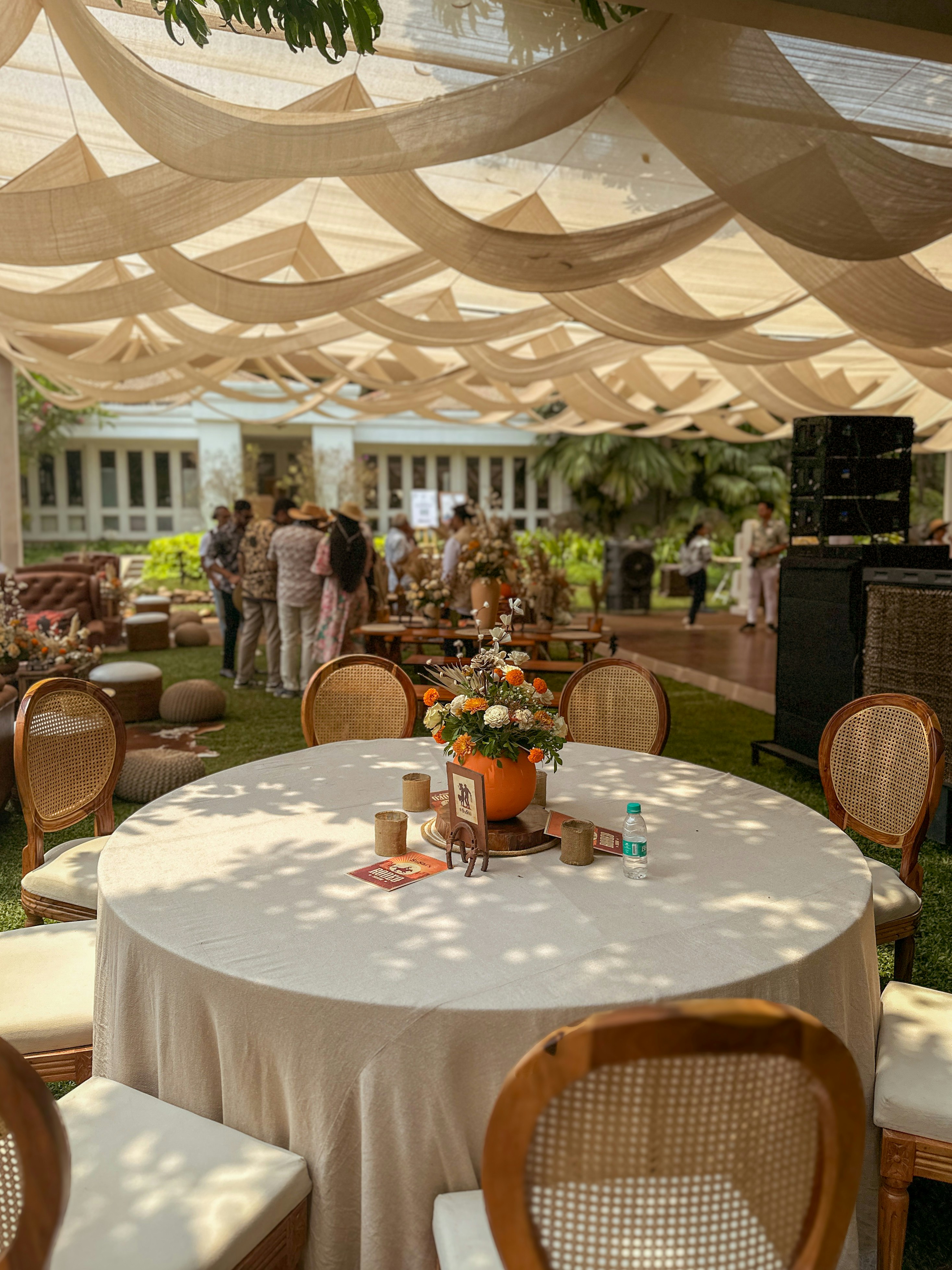 Outdoor party setup with elegant table and decorations.