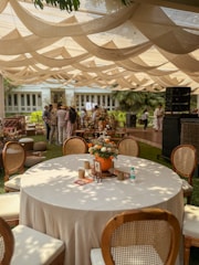 Outdoor party setup with elegant table and decorations.