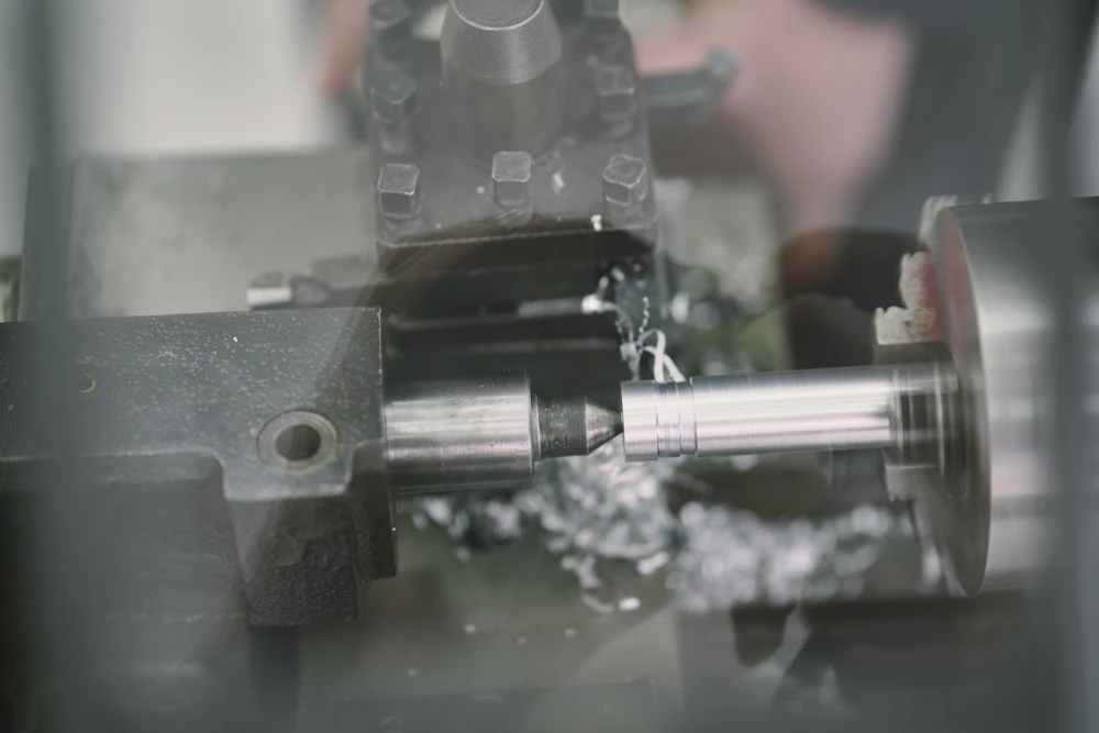 CNC lathe turning a metal rod