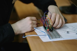 Someone is working on a circuit board.