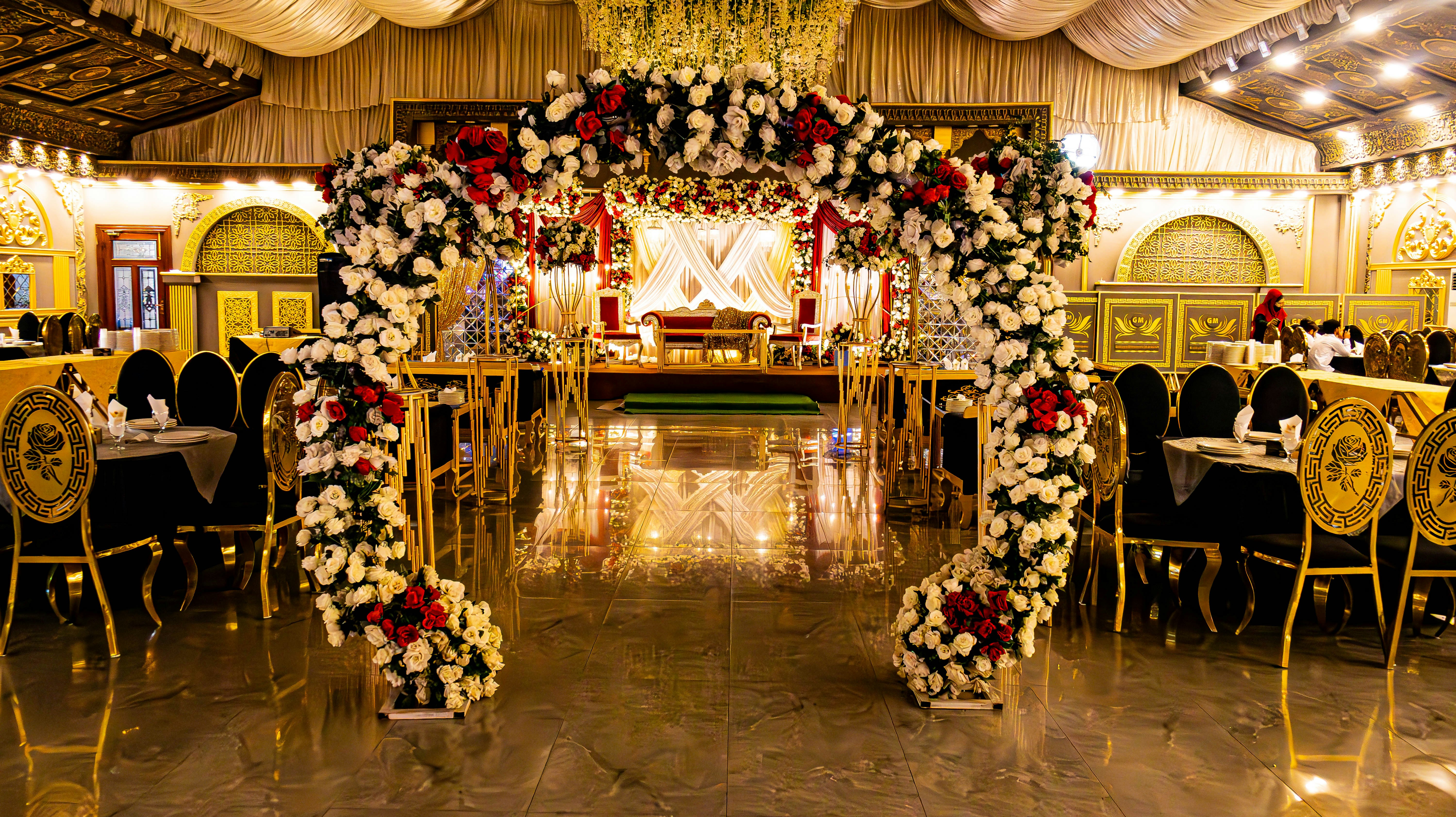 Elegant wedding hall with floral decorations.