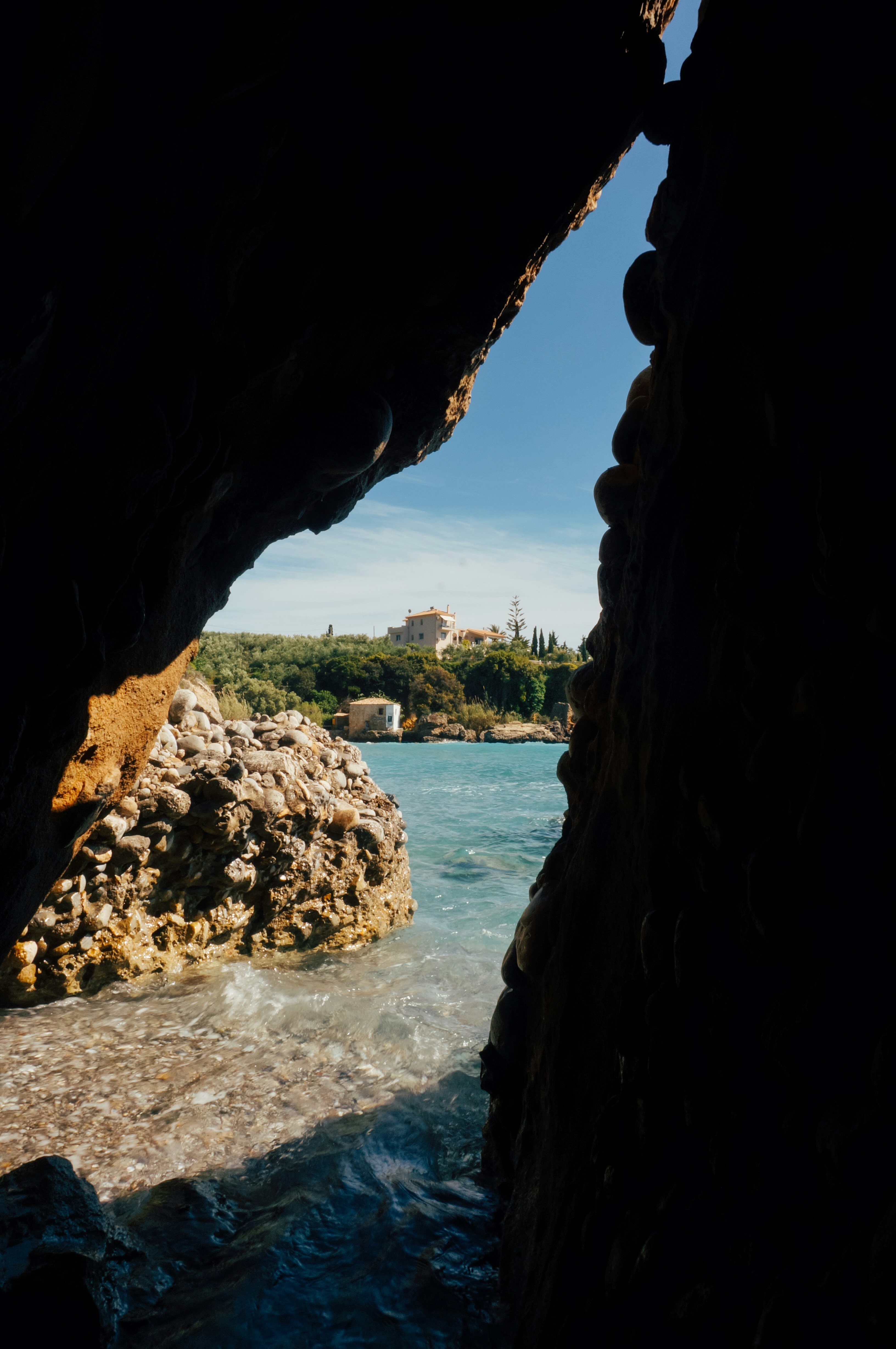 A coastal view framed by a rocky opening.
