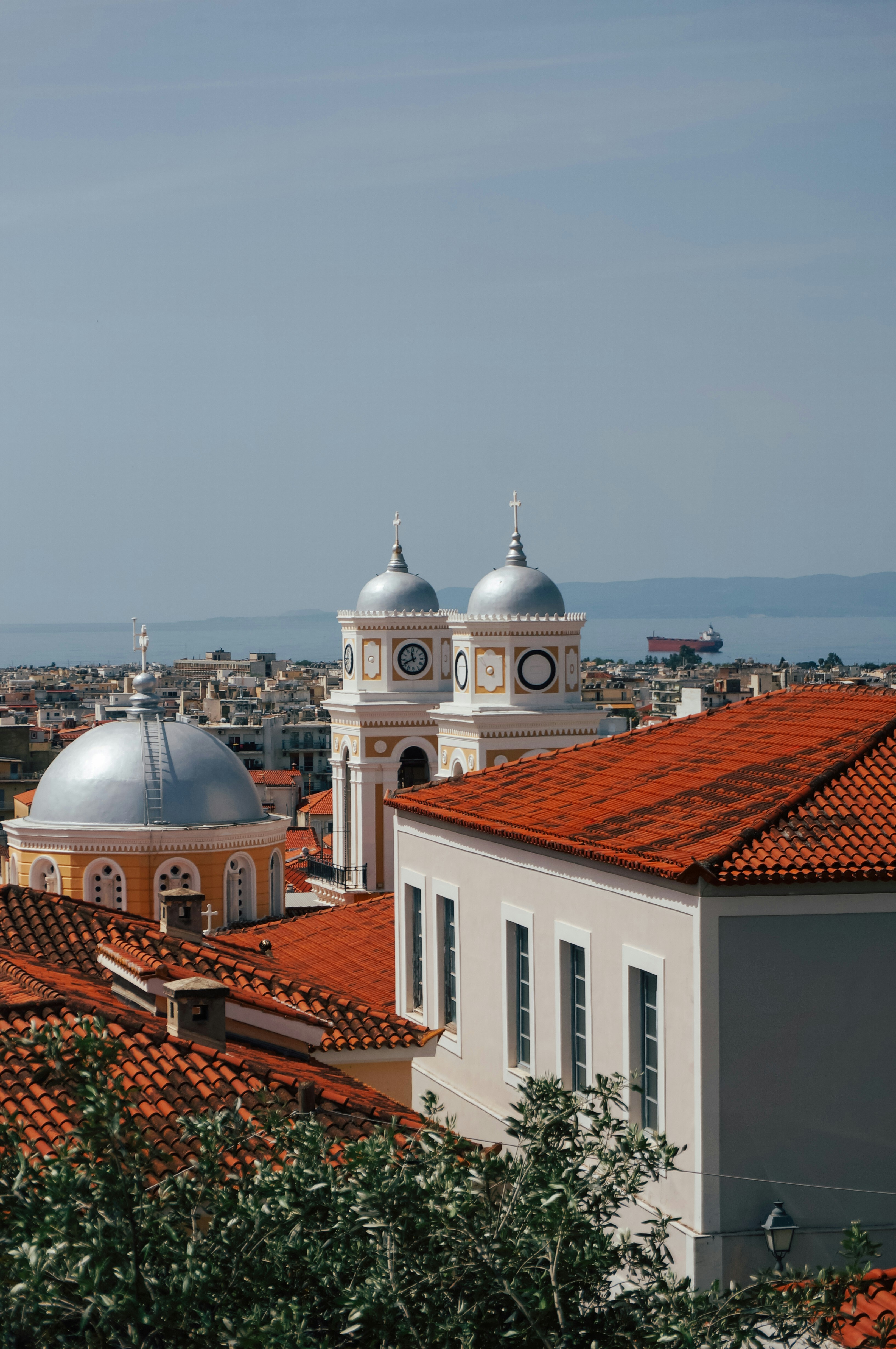 A church with domes sits above the city.