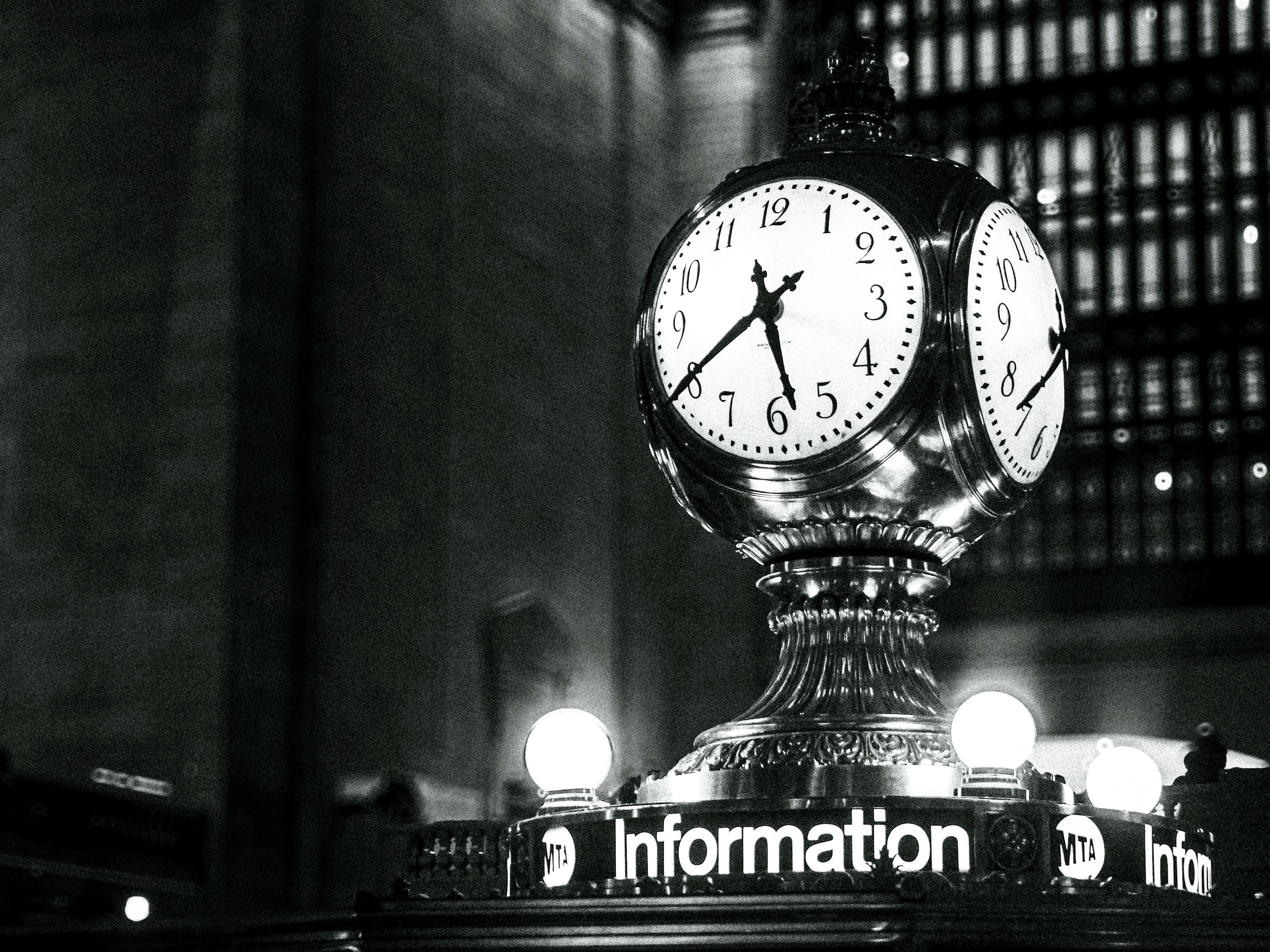 A classic clock stands in a grand station.