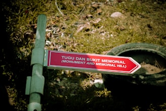 A sign points towards the monument and memorial mill.