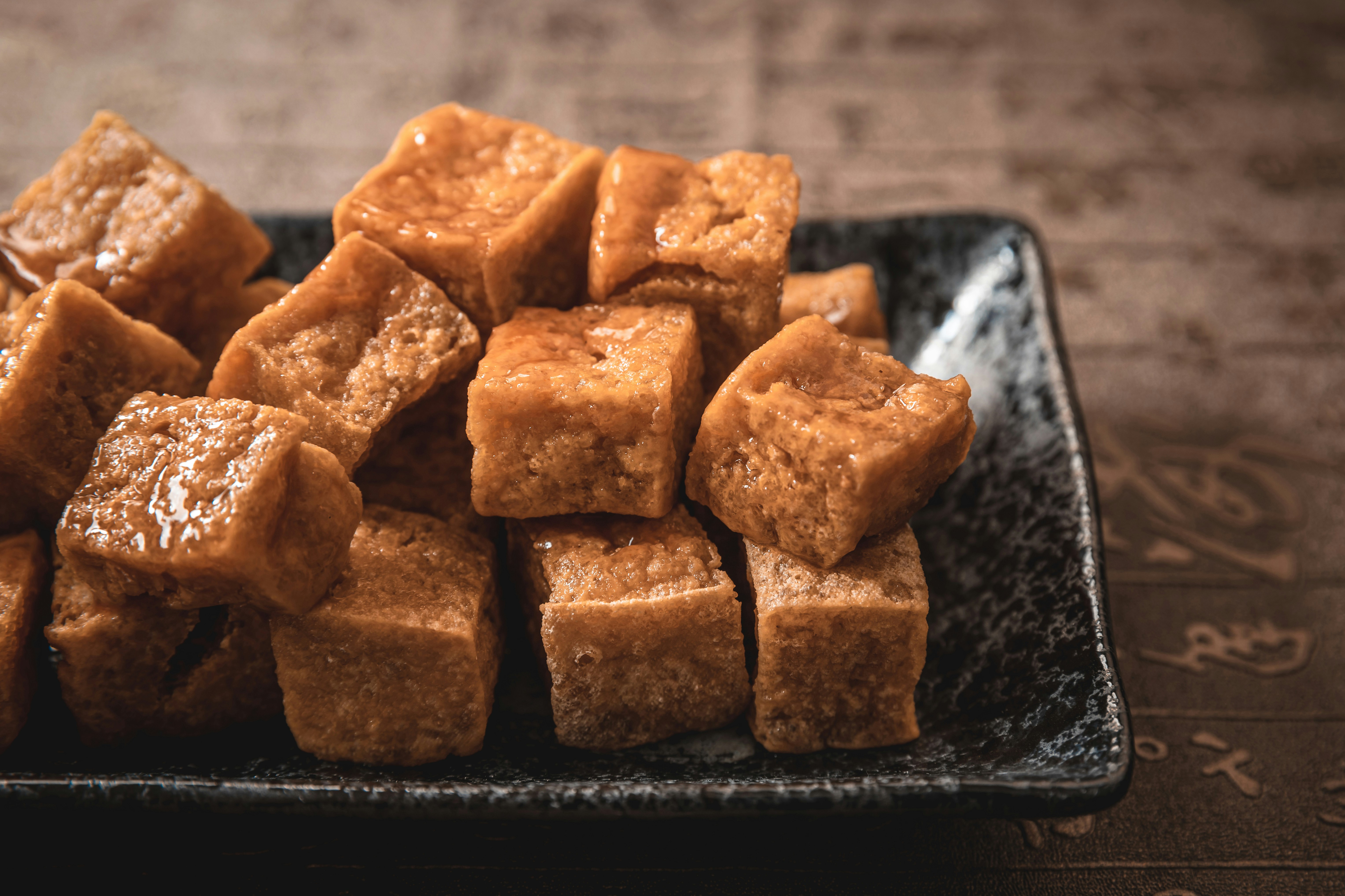 Fried tofu cubes are piled on a plate.