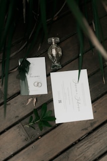 Wedding invitation details and a decorative perfume bottle.