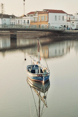 A small boat floats calmly in still water.