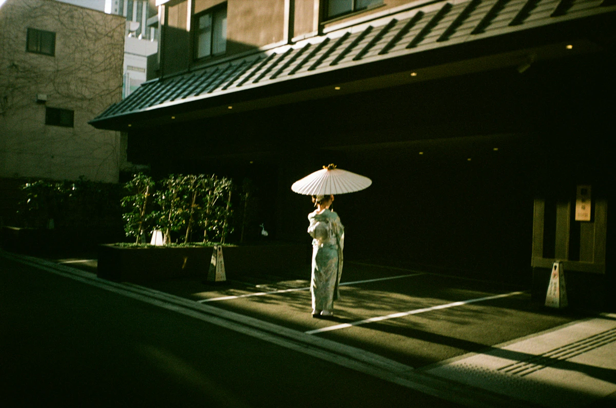 A woman in kimono with an umbrella.