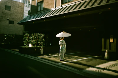 A woman in kimono with an umbrella.