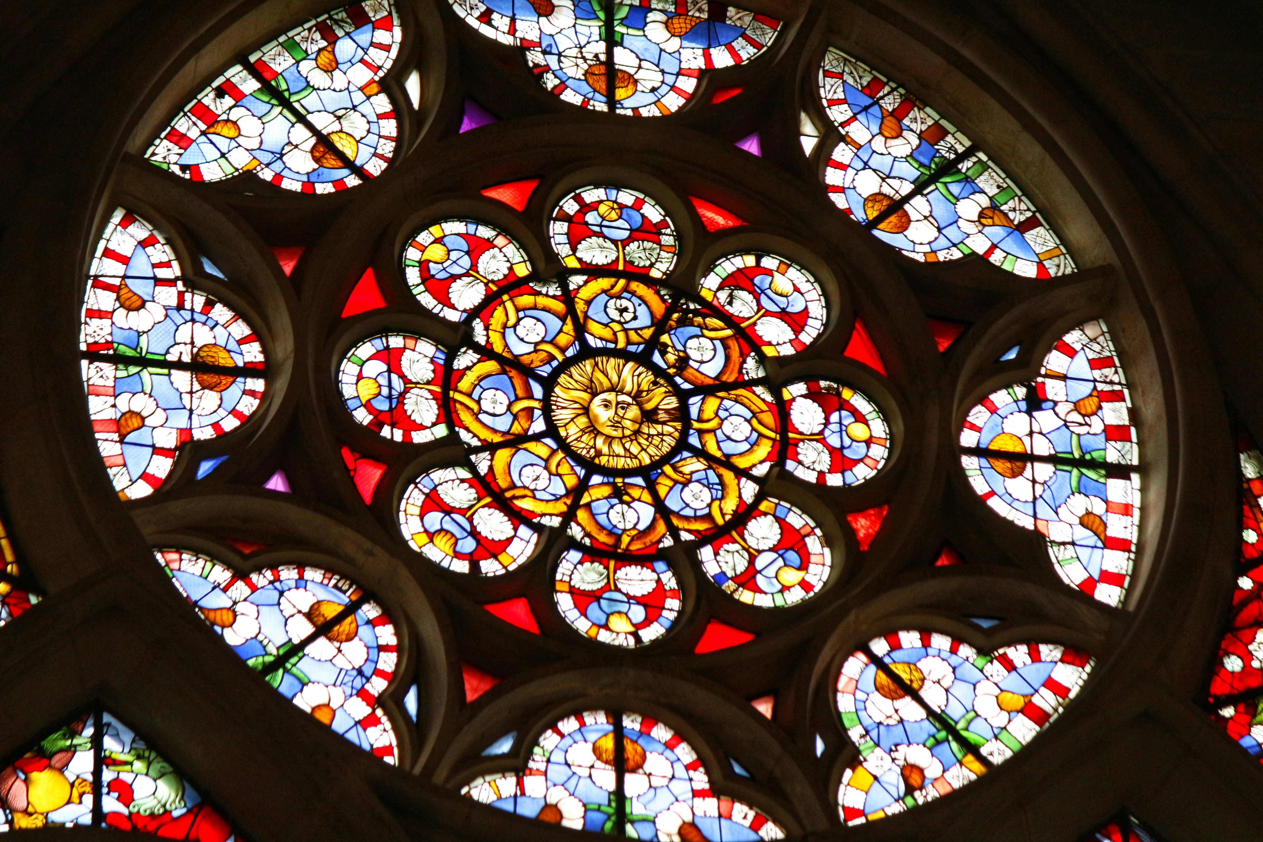 Colorful stained-glass window with a floral pattern.