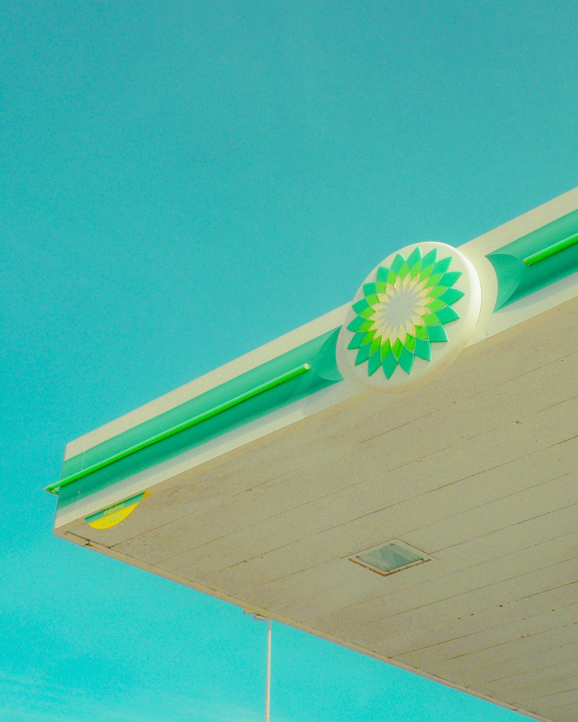 Bp gas station canopy against a bright blue sky.