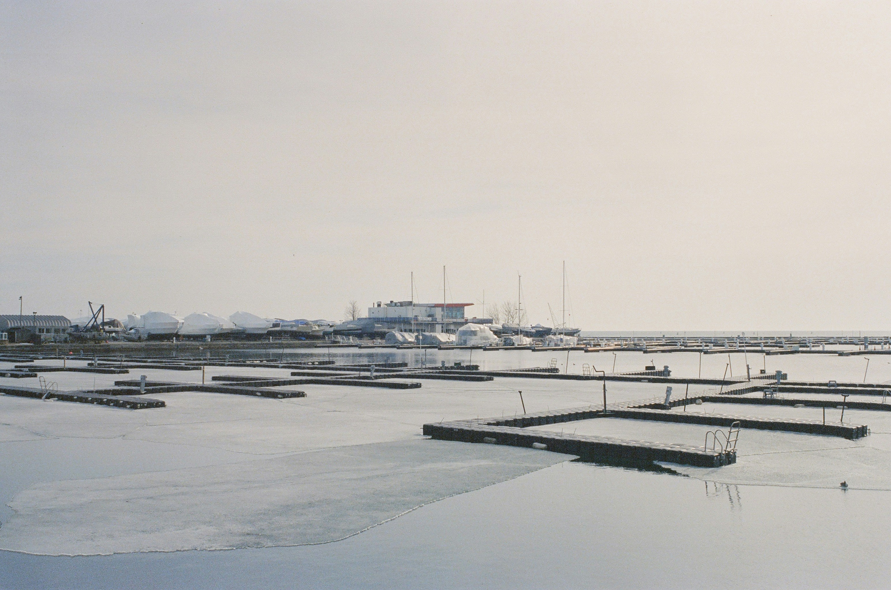 A misty harbor with empty docks.