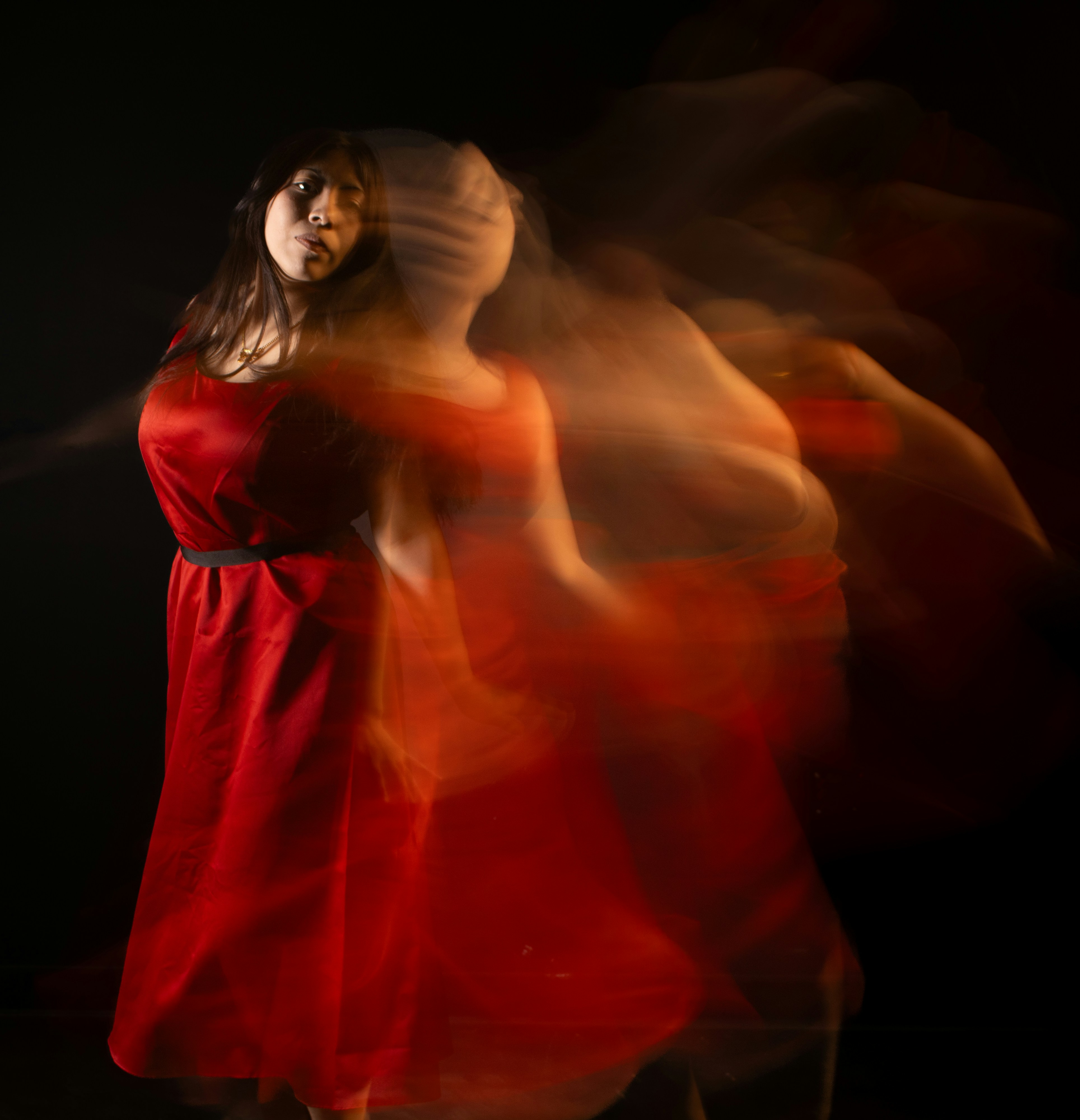 A woman in red dress appears to be moving.