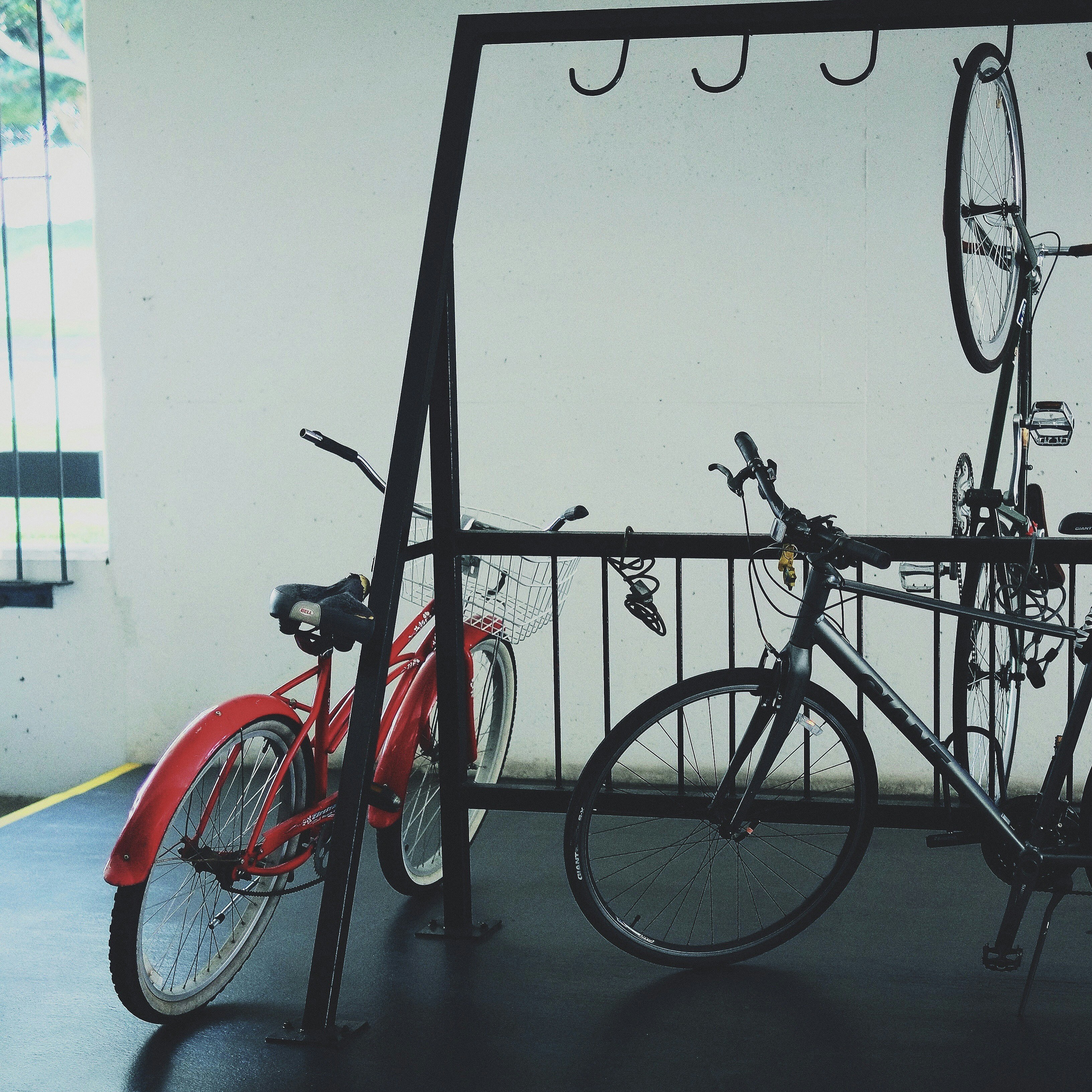 Bikes parked near a rack inside a building.
