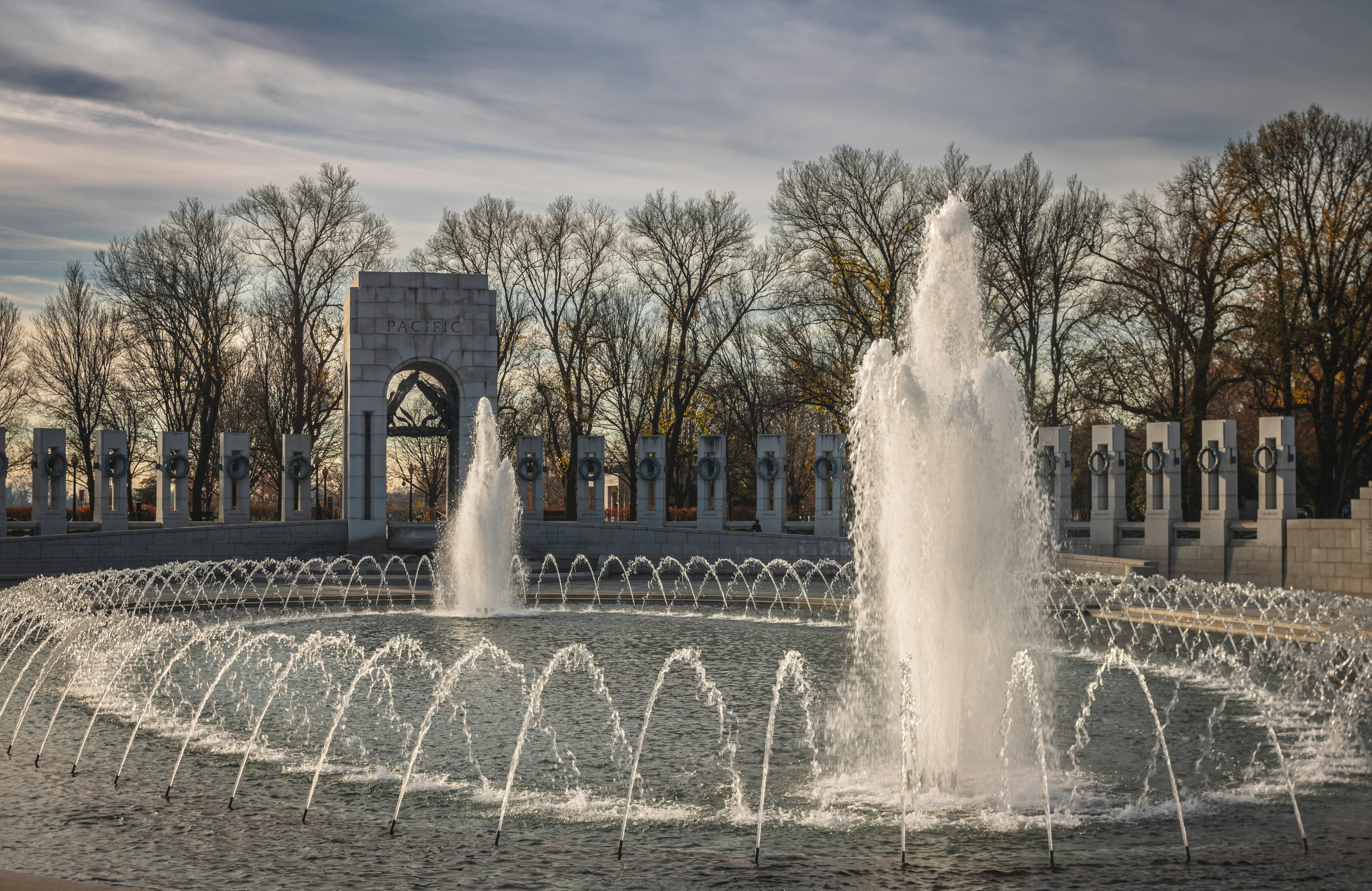 The world war ii memorial's fountains spray water.