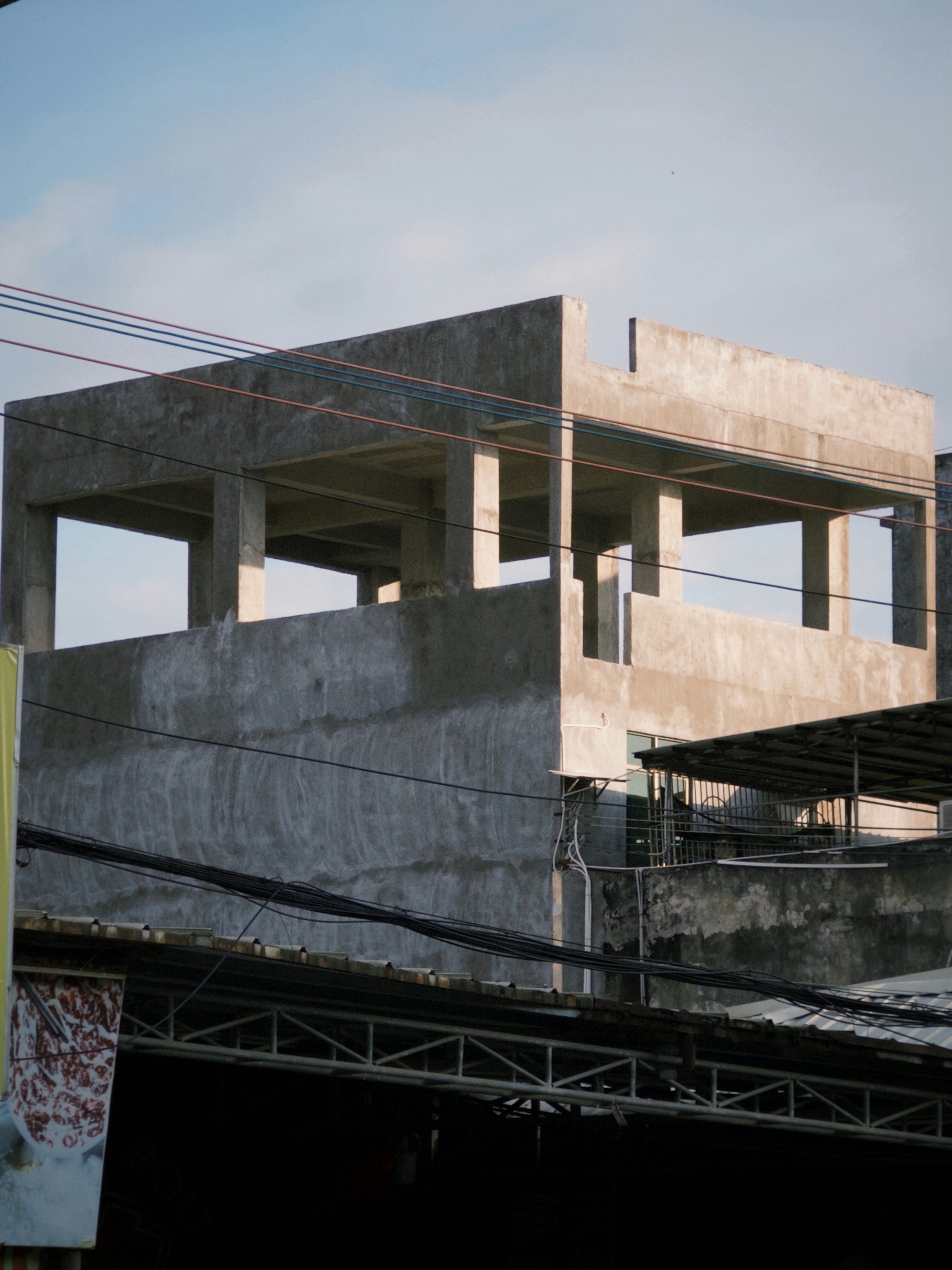 Concrete building under construction, blue sky in background