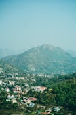 A scenic view of a town nestled by a mountain.