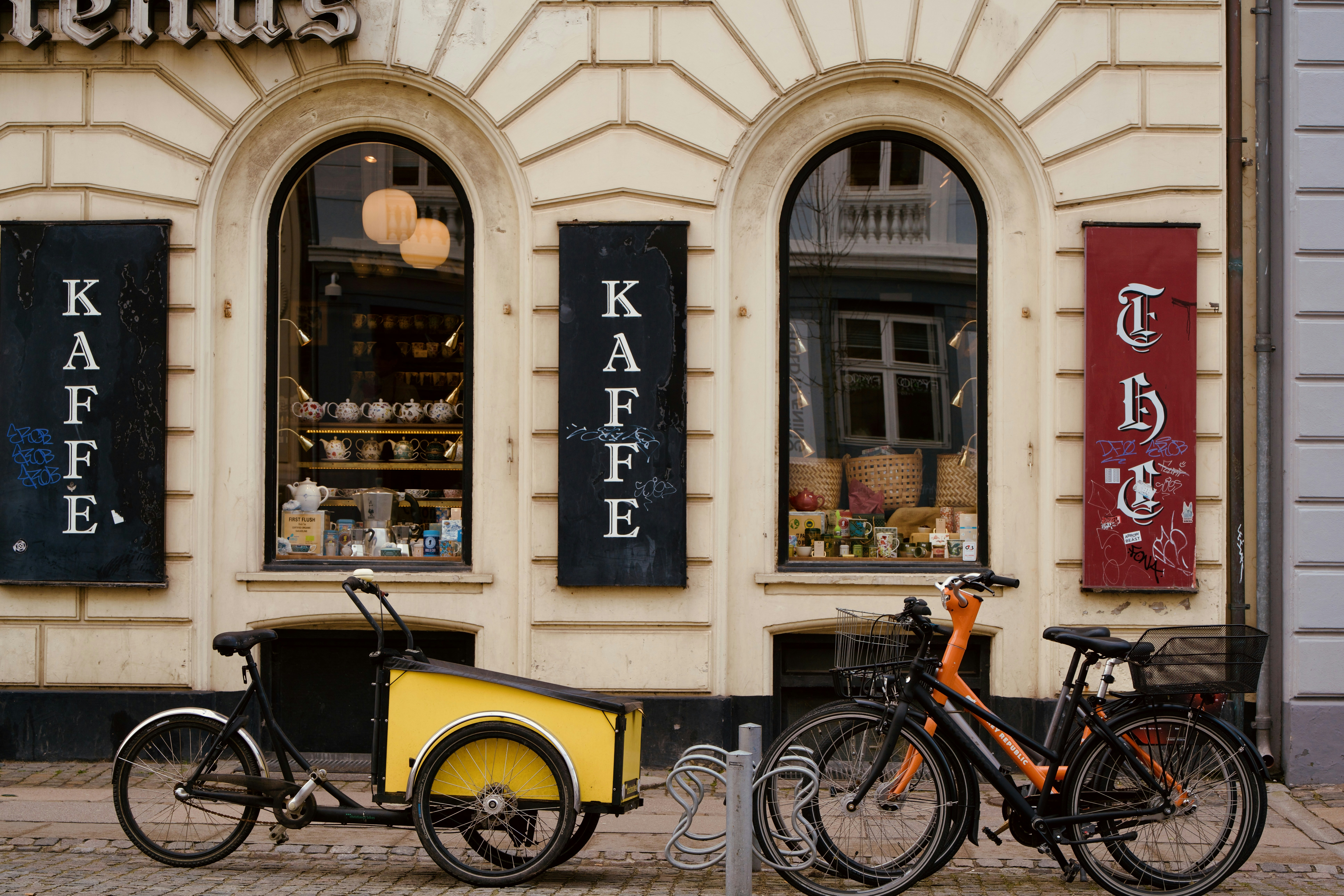 A cafe's facade with bicycles parked outside.