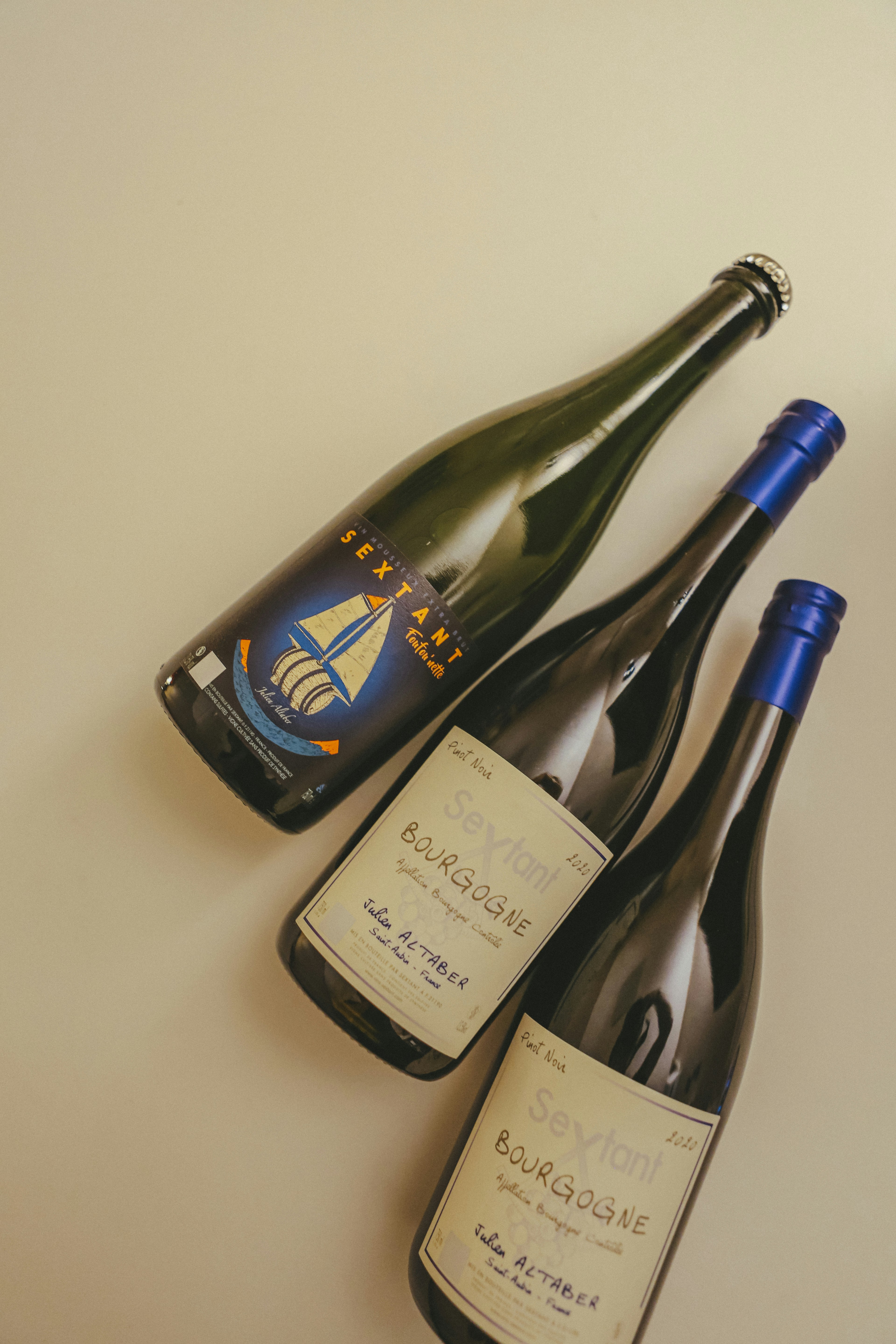 Bottles of wine from sextant are arranged on a surface.