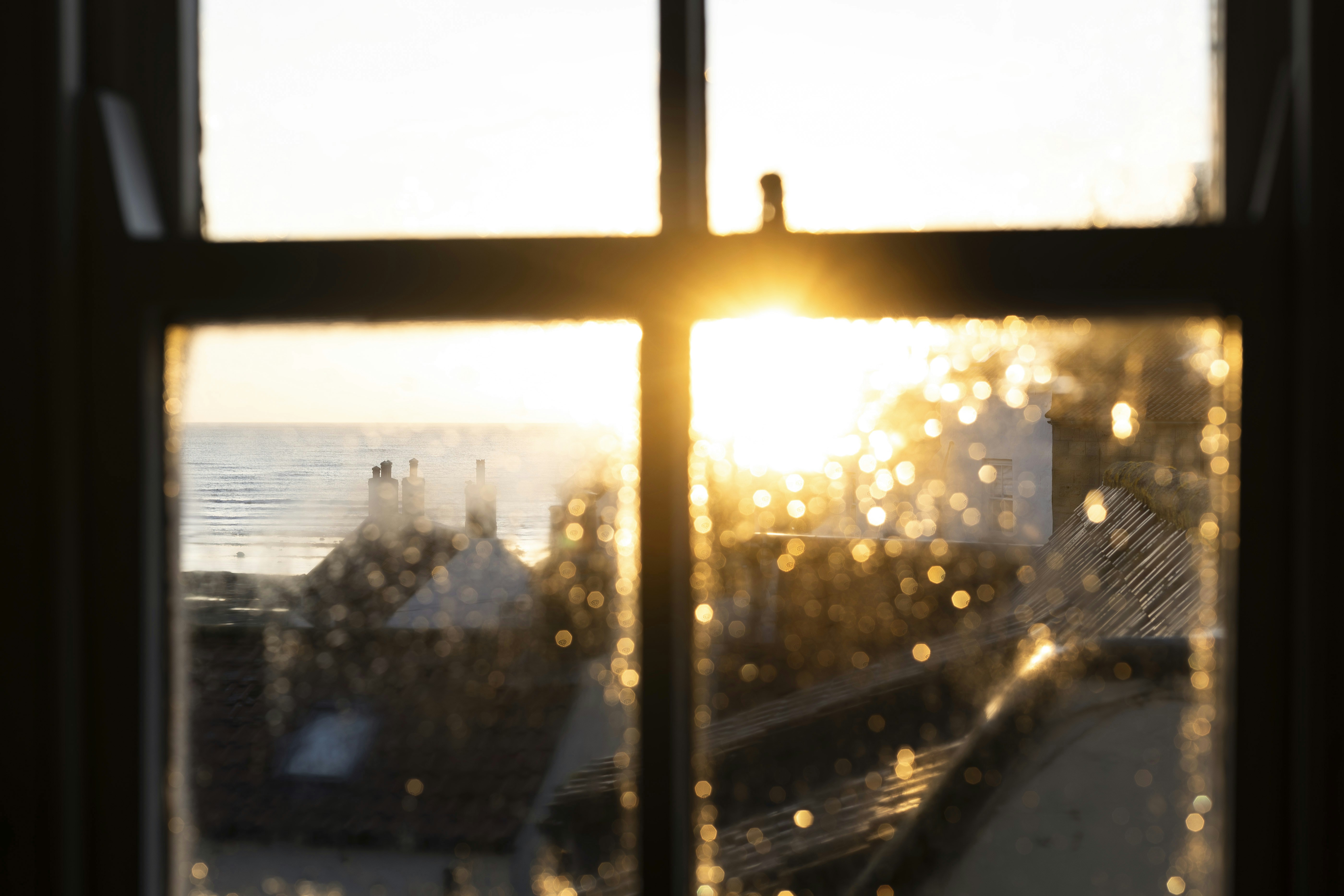 Sunset shines through a window, illuminating outside.