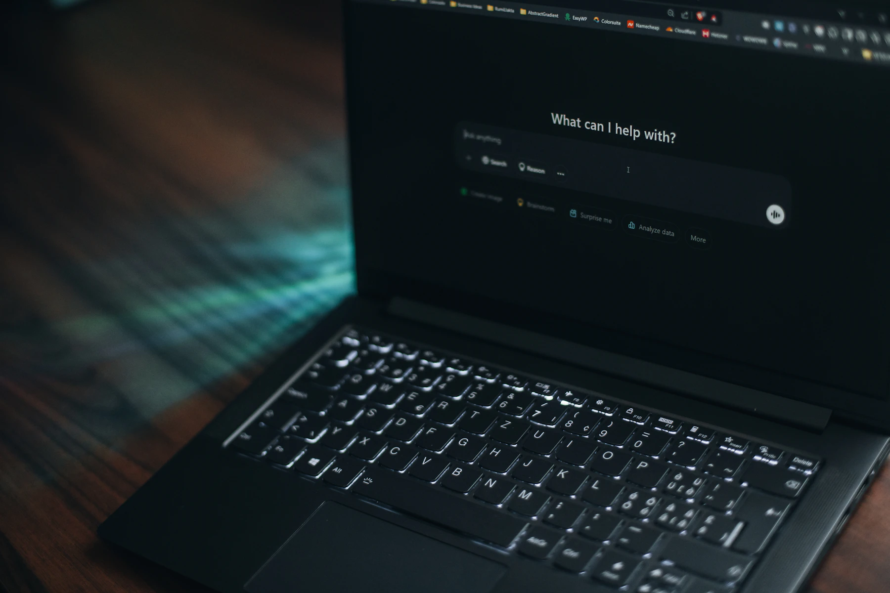 Laptop displaying an artificial-intelligence search interface in a dark workspace