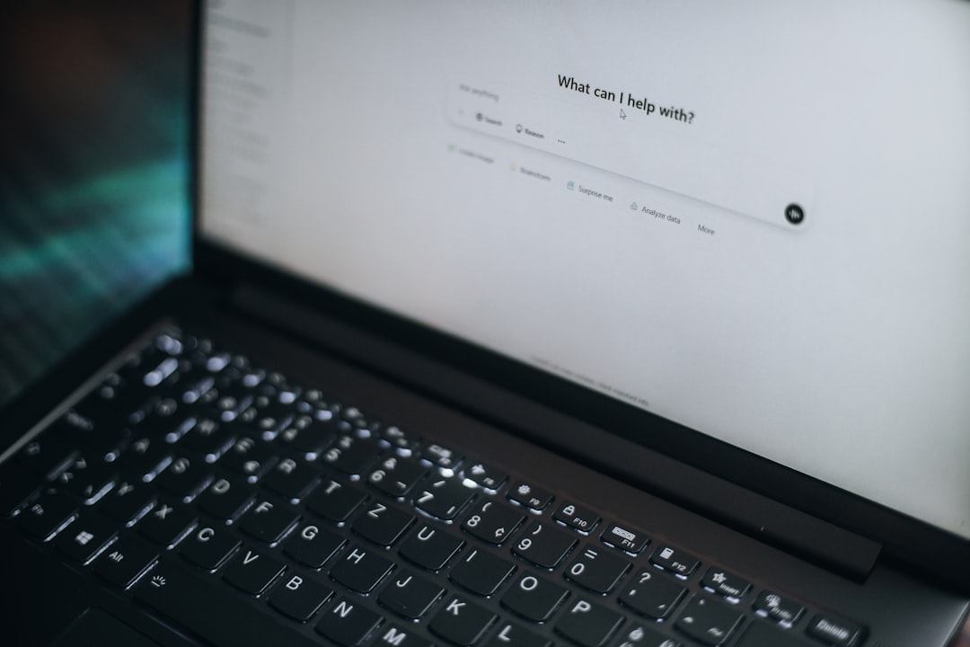 A laptop displays "what can i help with?", Chatgpt