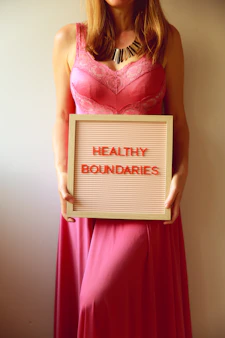 Woman holds a sign promoting healthy boundaries