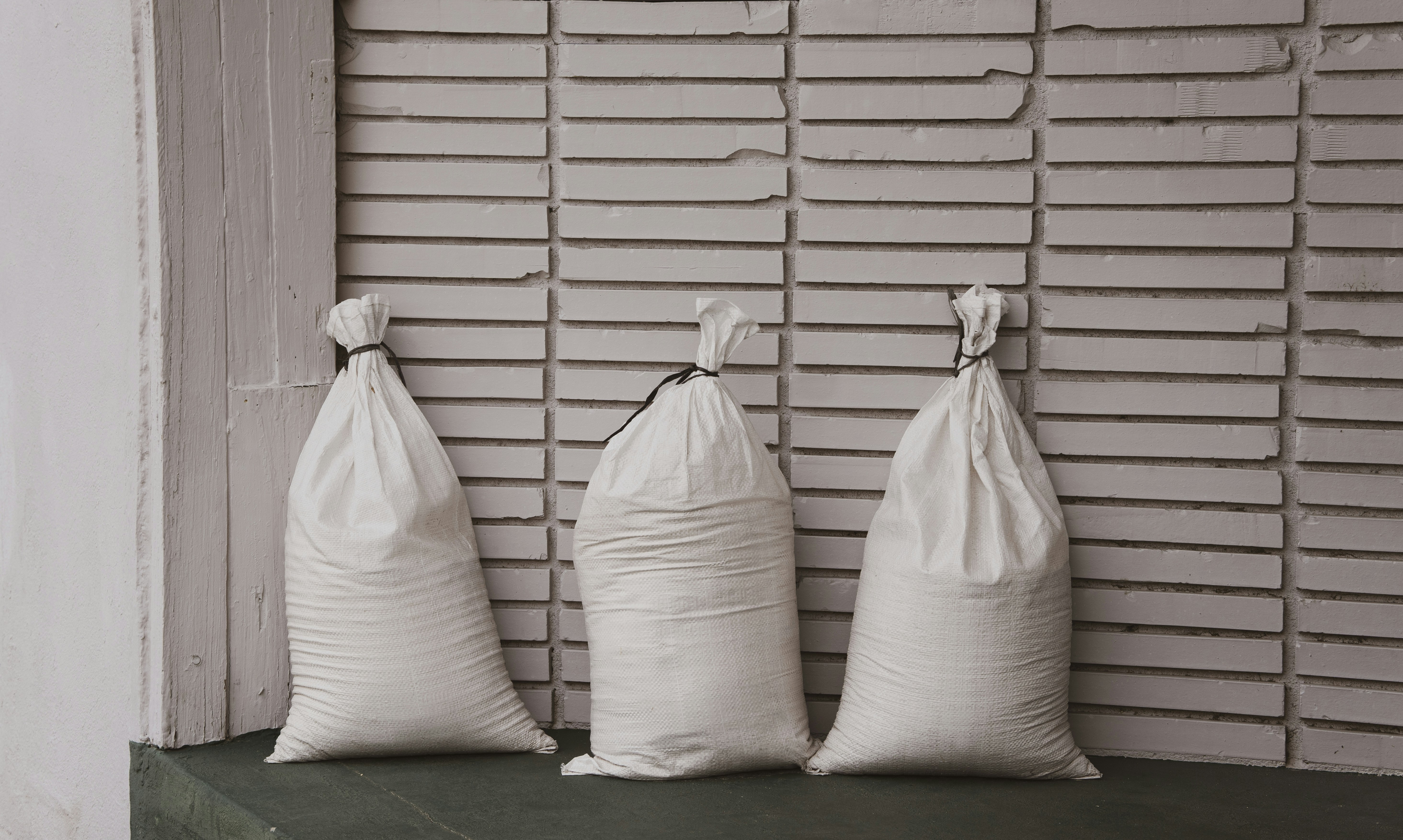 White grain sacks against striped wall