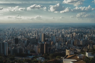 Vast cityscape stretches towards the horizon under a cloudy sky.