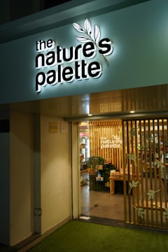 The nature's palette store entrance at night.