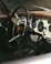 Classic car's interior with steering wheel and gauges.