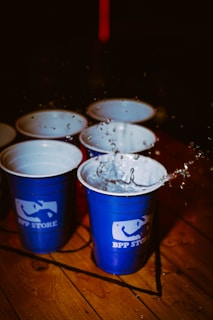 Water splashes from a cup in a beer pong game.
