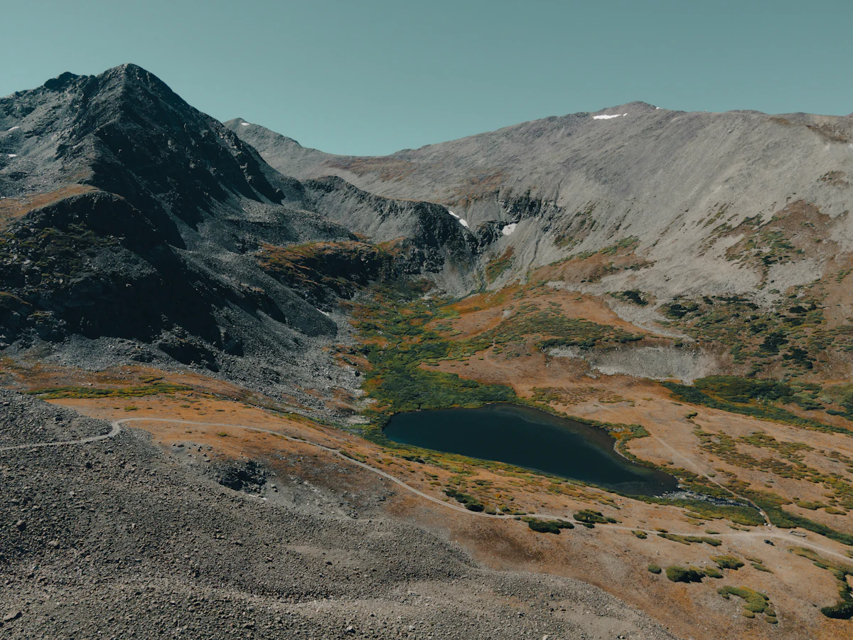 An alpine lake in a high basin below a rocky peak near Breckenridge, seen from above
