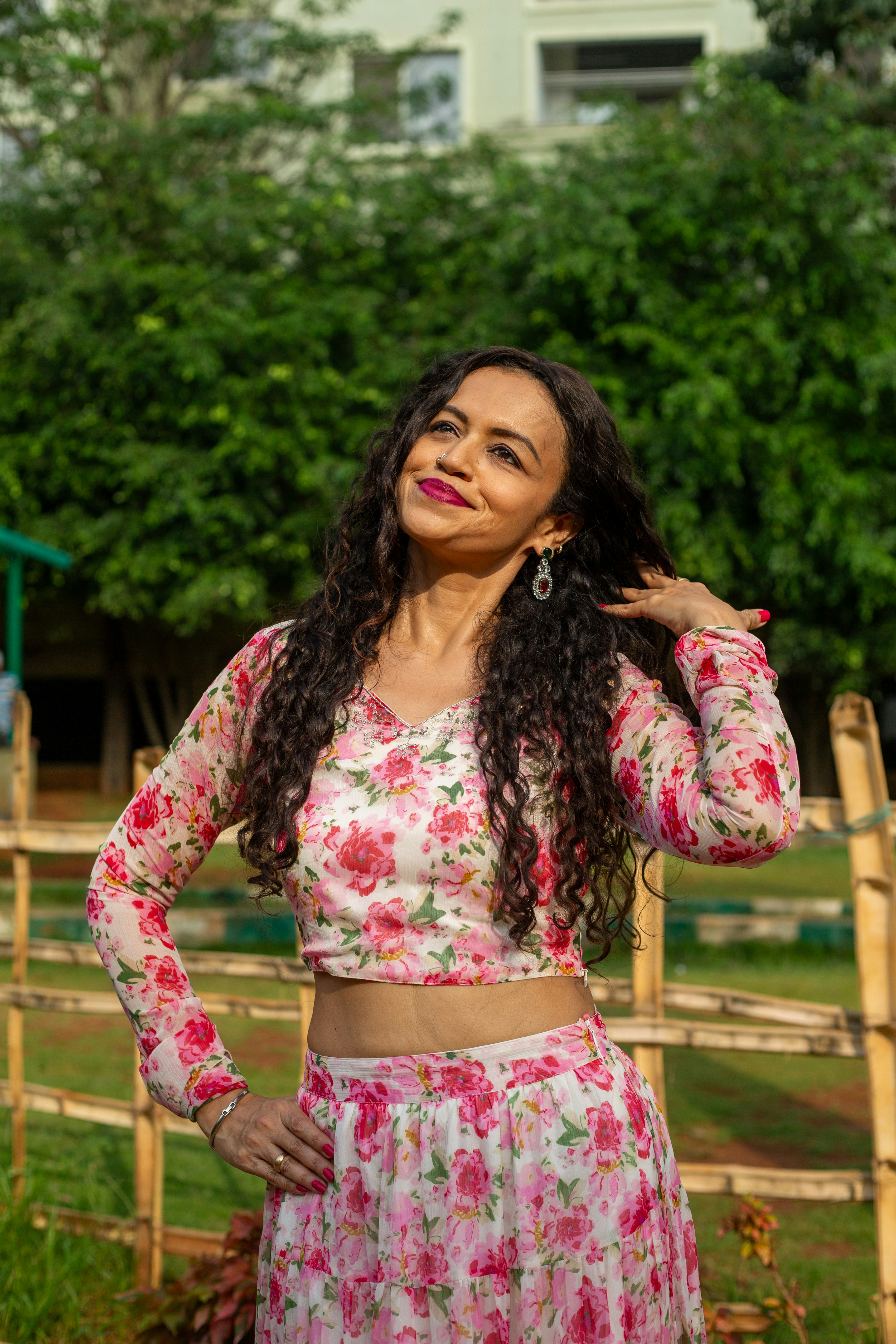 Eine Frau posiert in einem geblümten Outfit.