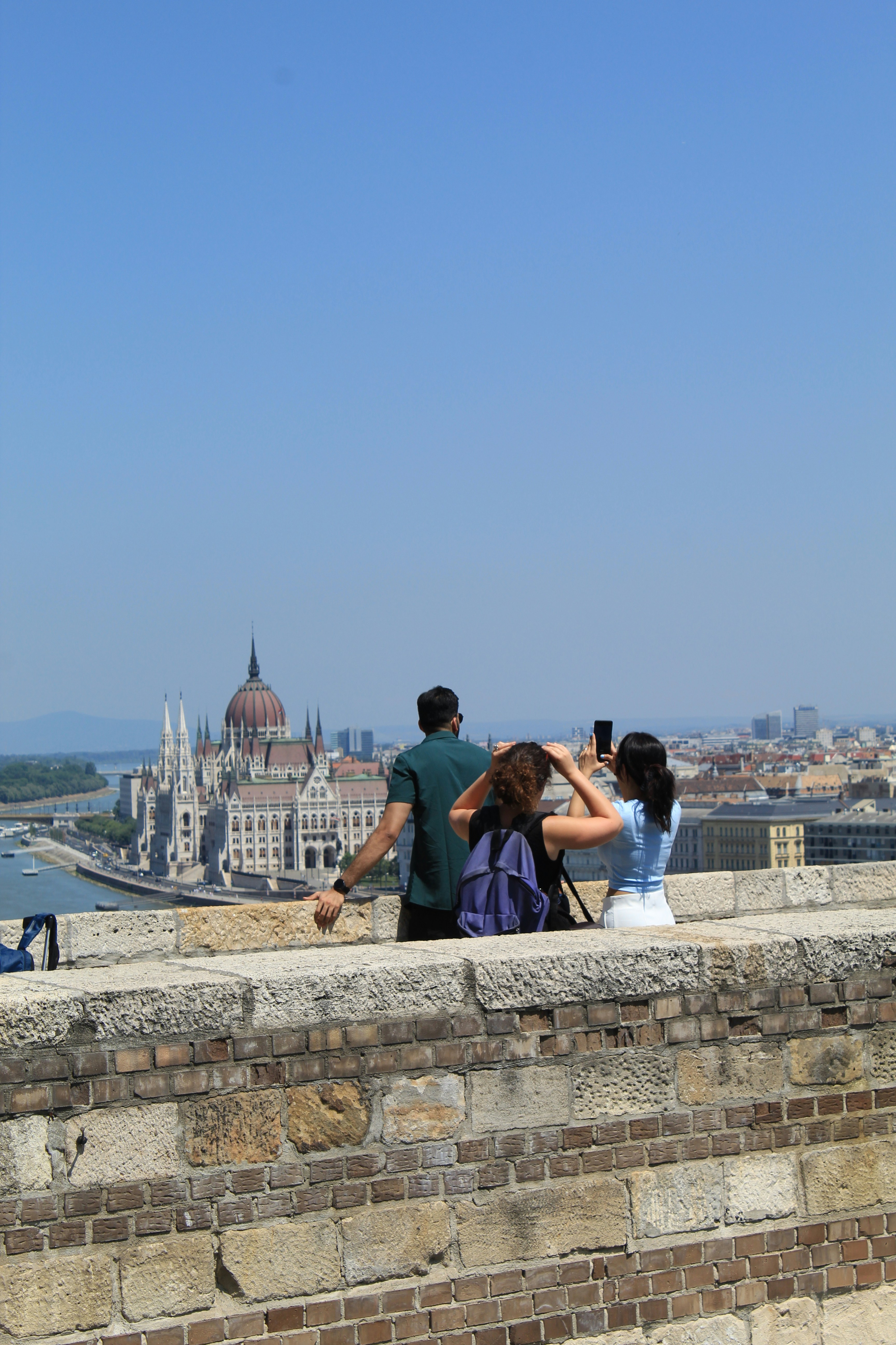 People take pictures with a scenic city view.
