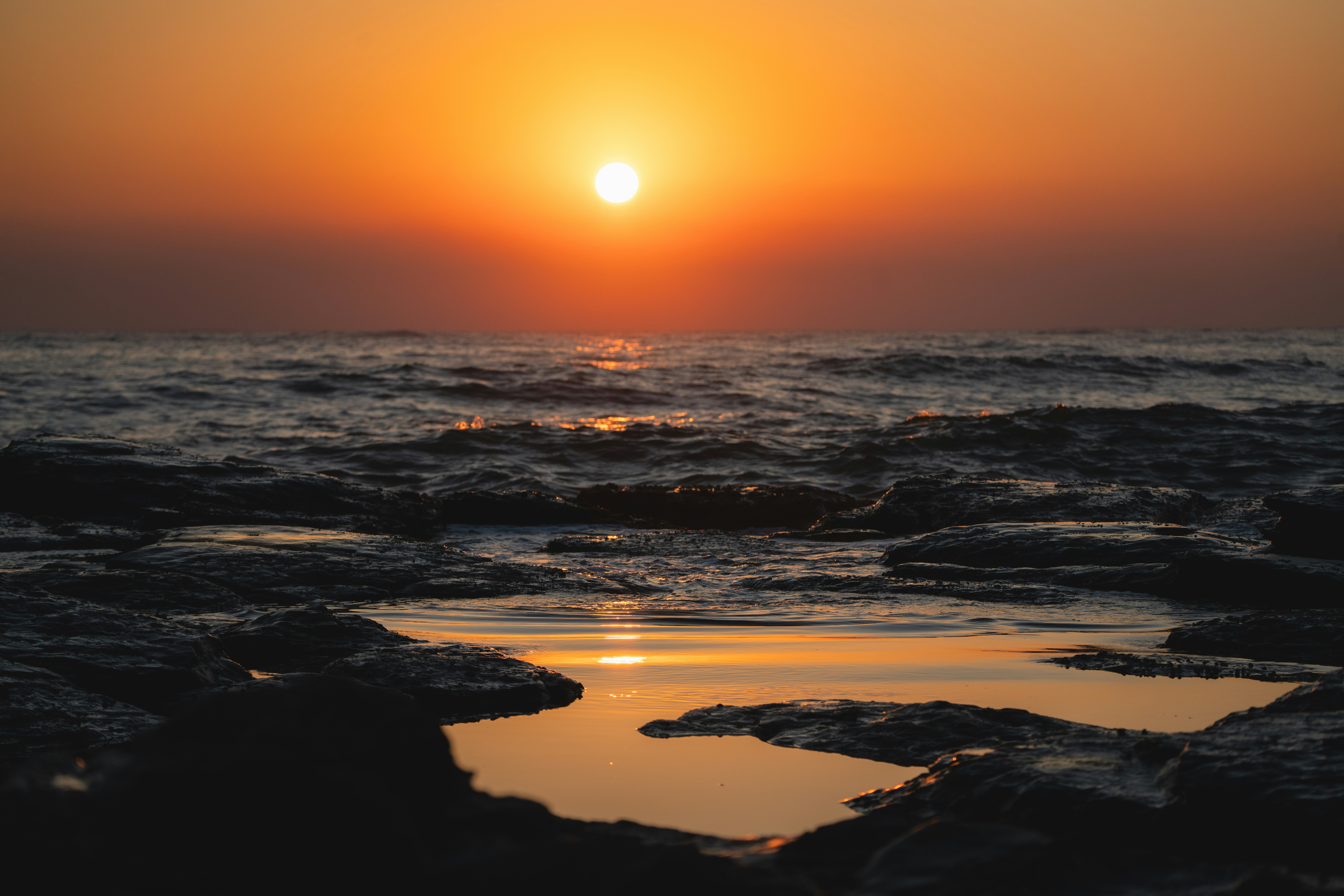 Sunset over the ocean with a golden glow.