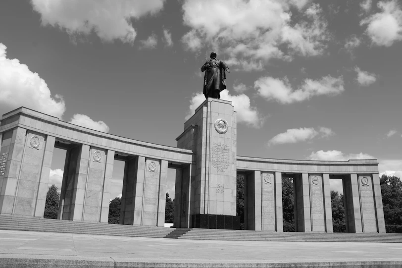 A soviet war memorial with a statue.