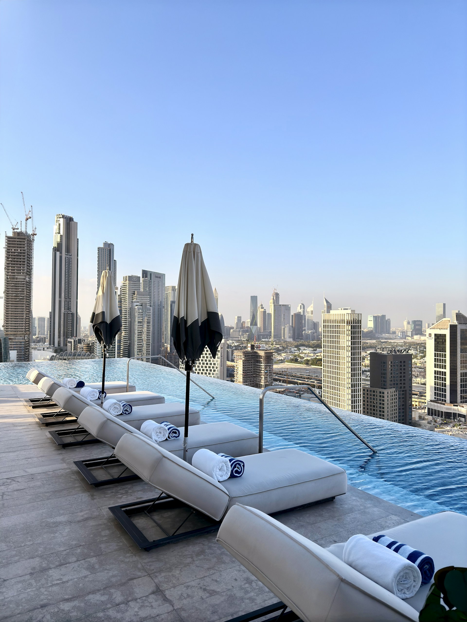 Relaxing pool overlooks a city skyline.