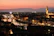 Sunset over florence, italy, with illuminated buildings.