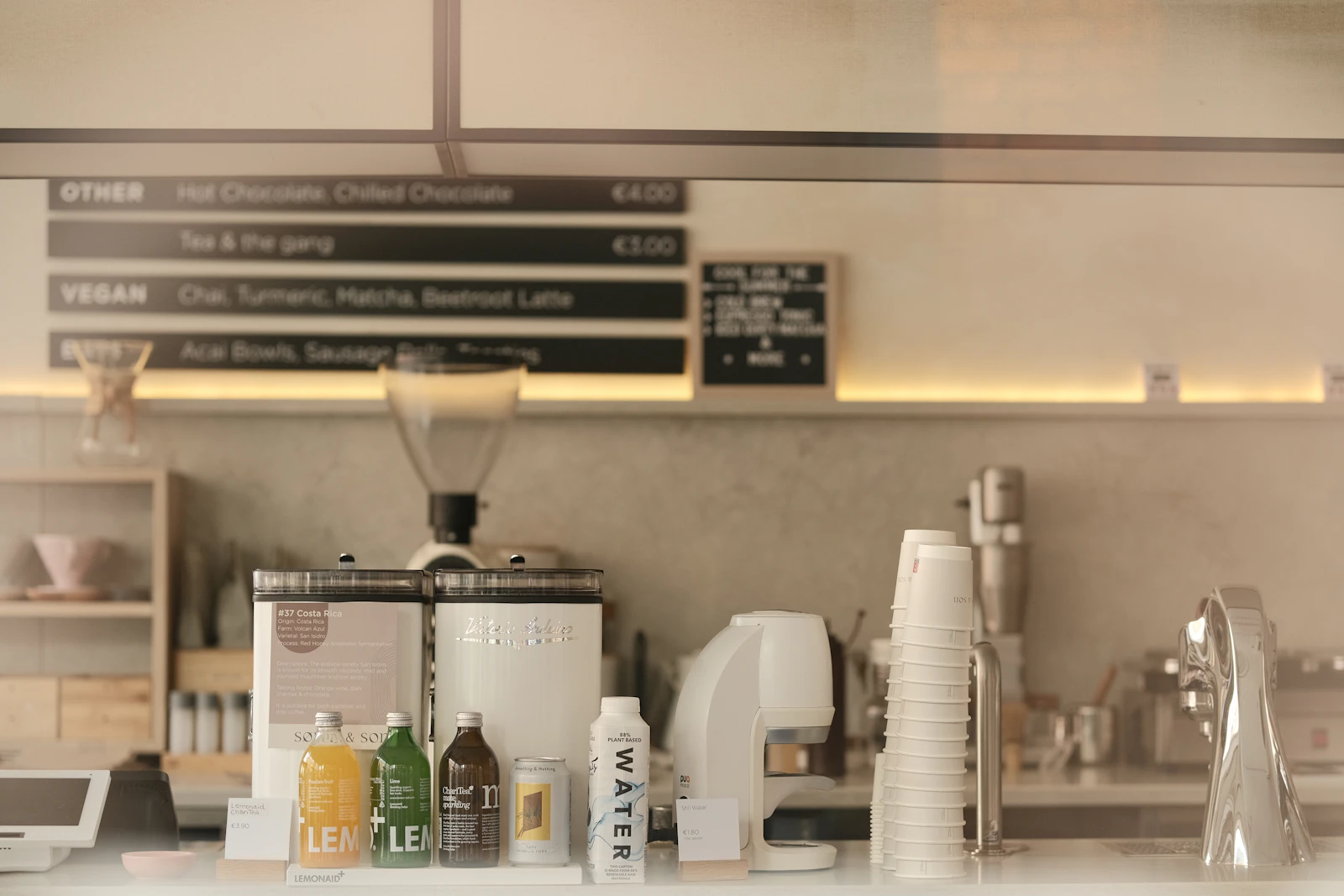 Bright, clean café counter with menu board and coffee equipment
